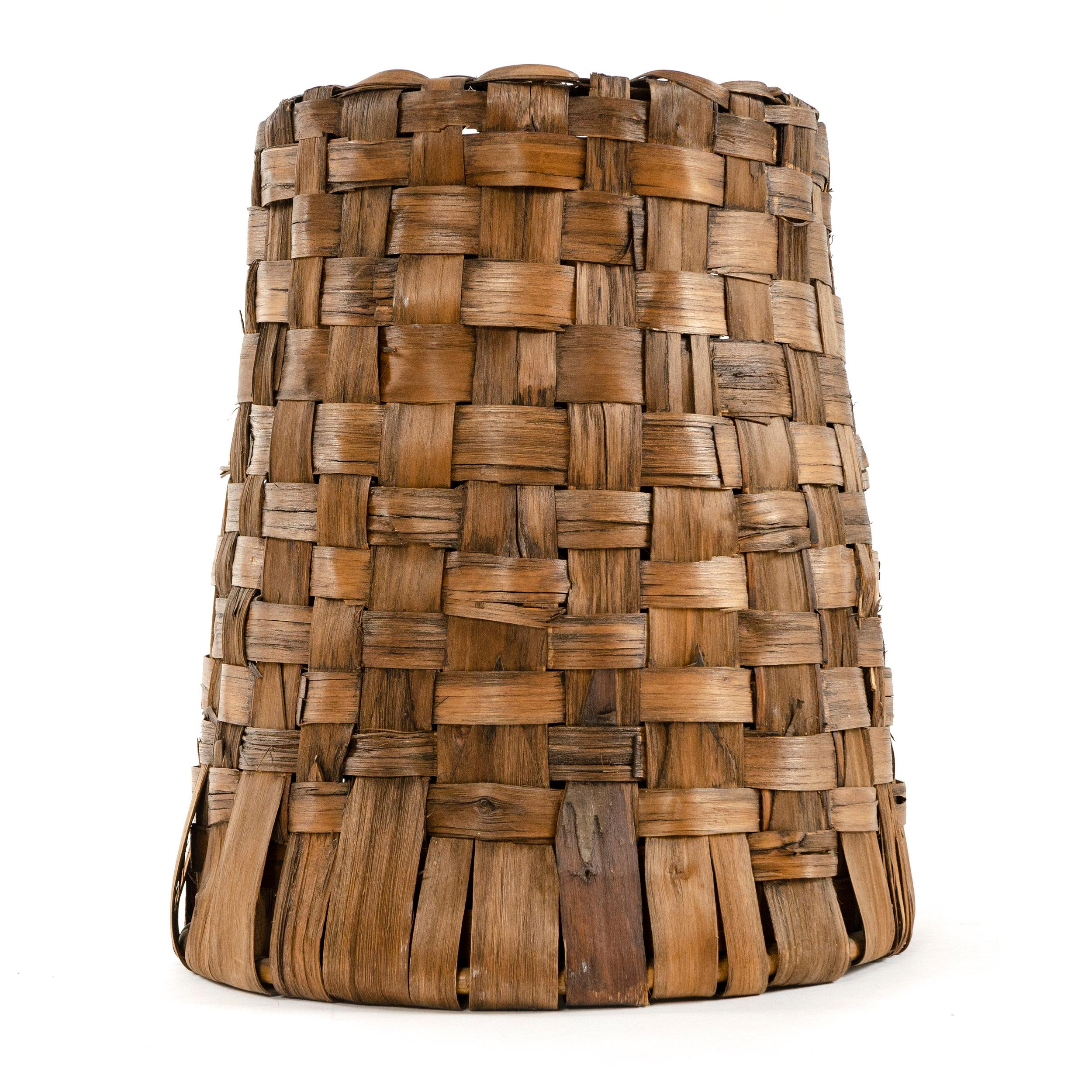 A steel frame lamp shade with woven bark covering.