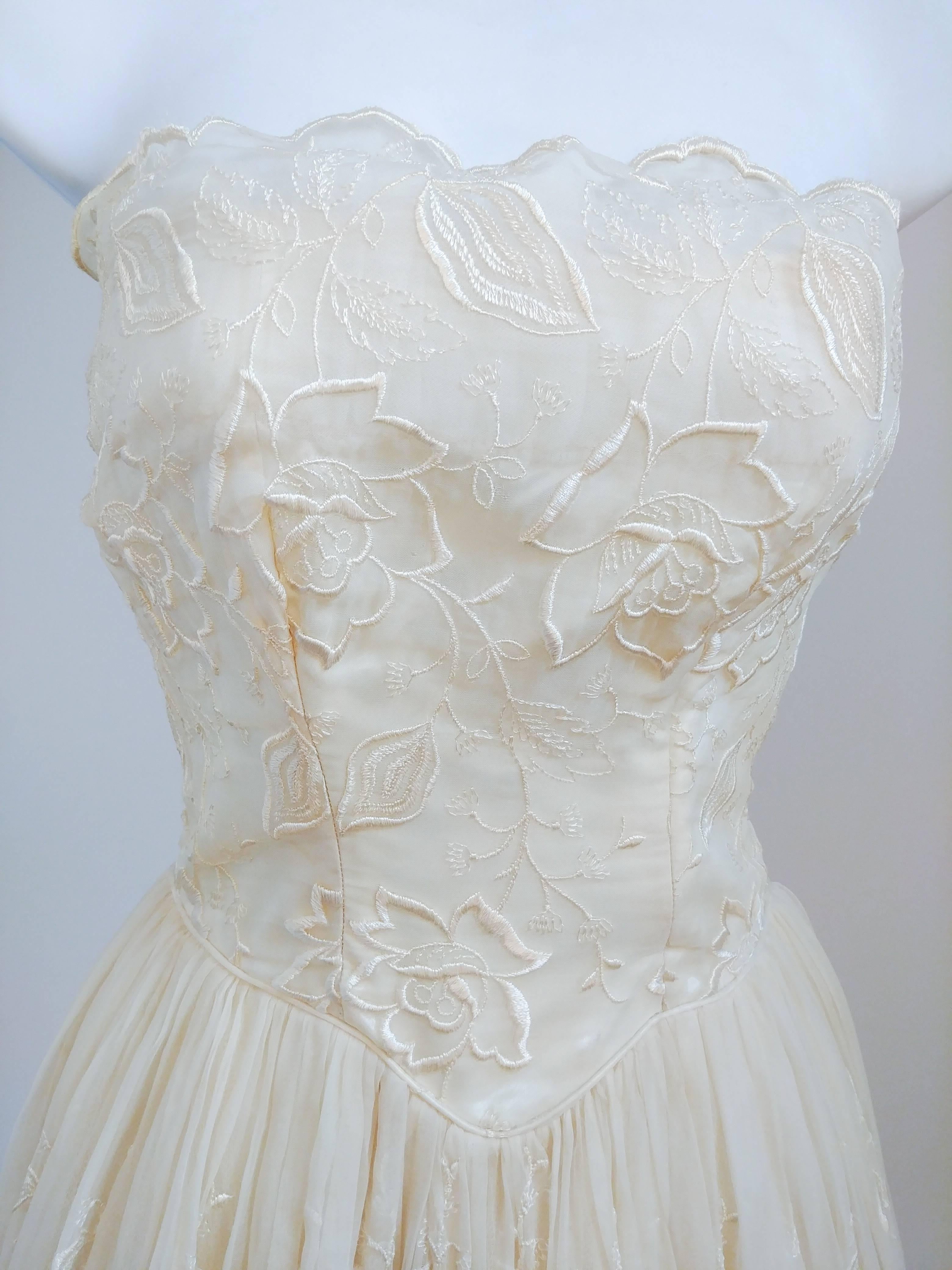 1950s Ivory Strapless Embroidered Lace Gown. Strapless bodice with embroidered rose lace overlay, basque waist, and full gathered skirt. Zips up back.  