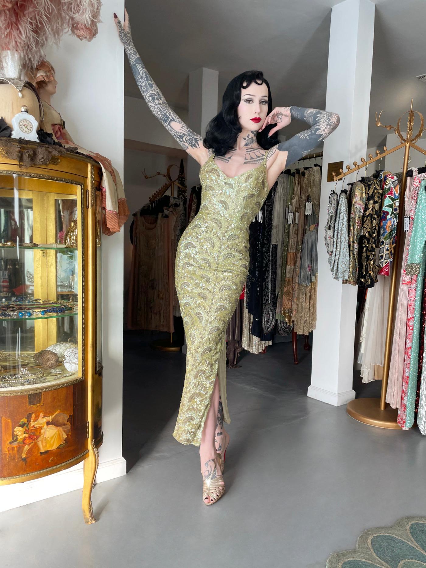 A truly breathtaking and incredibly rare Jacqueline of Paris sparkling chartreuse fully-beaded silk hourglass gown dating back to the late 1950's. This piece is a true testament to the opulence and craftsmanship of mid-century French couture.
The