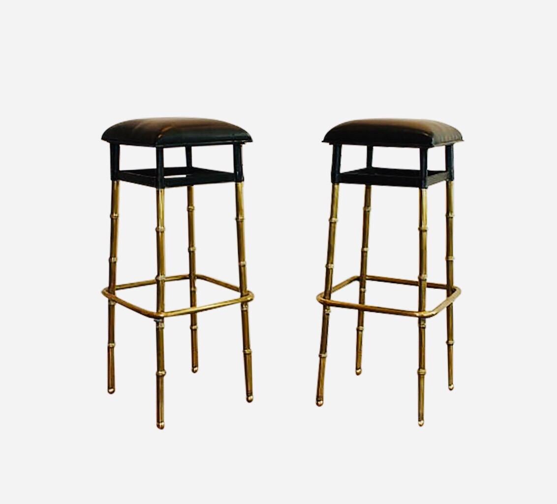 Pair of stools bar by Jacques Adnet.
Black hand stitched leather.
Brass bamboo style feet decorated with brass balls at the end of the feet.

Height 82 cm, width 35 cm, depth 35 cm.

 