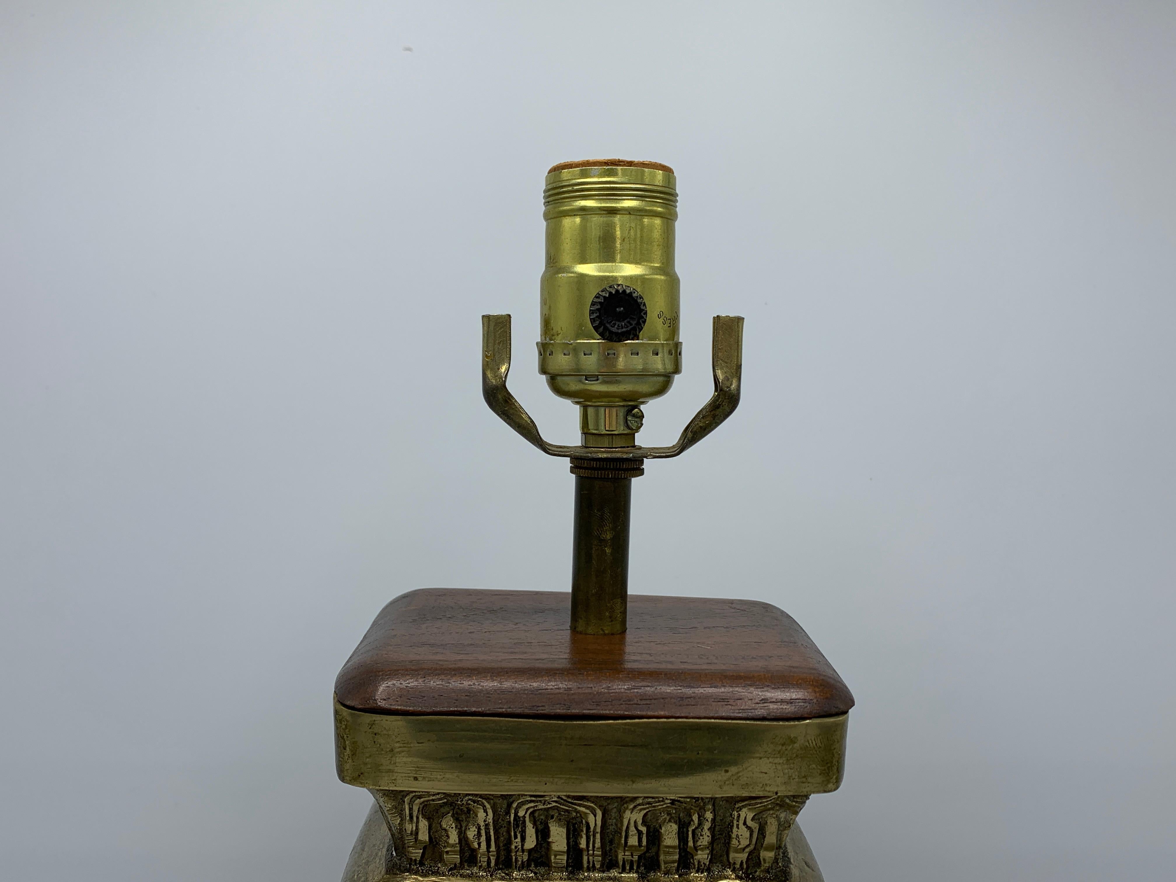 Offered is a fabulous, 1950s James Mont style, heavy brass chinoiserie censor lamp. The heavily detailed brass censor/urn body was custom-fit as a lamp, with a dark stained wood top and base. Heavy, weighing nearly 13lbs.