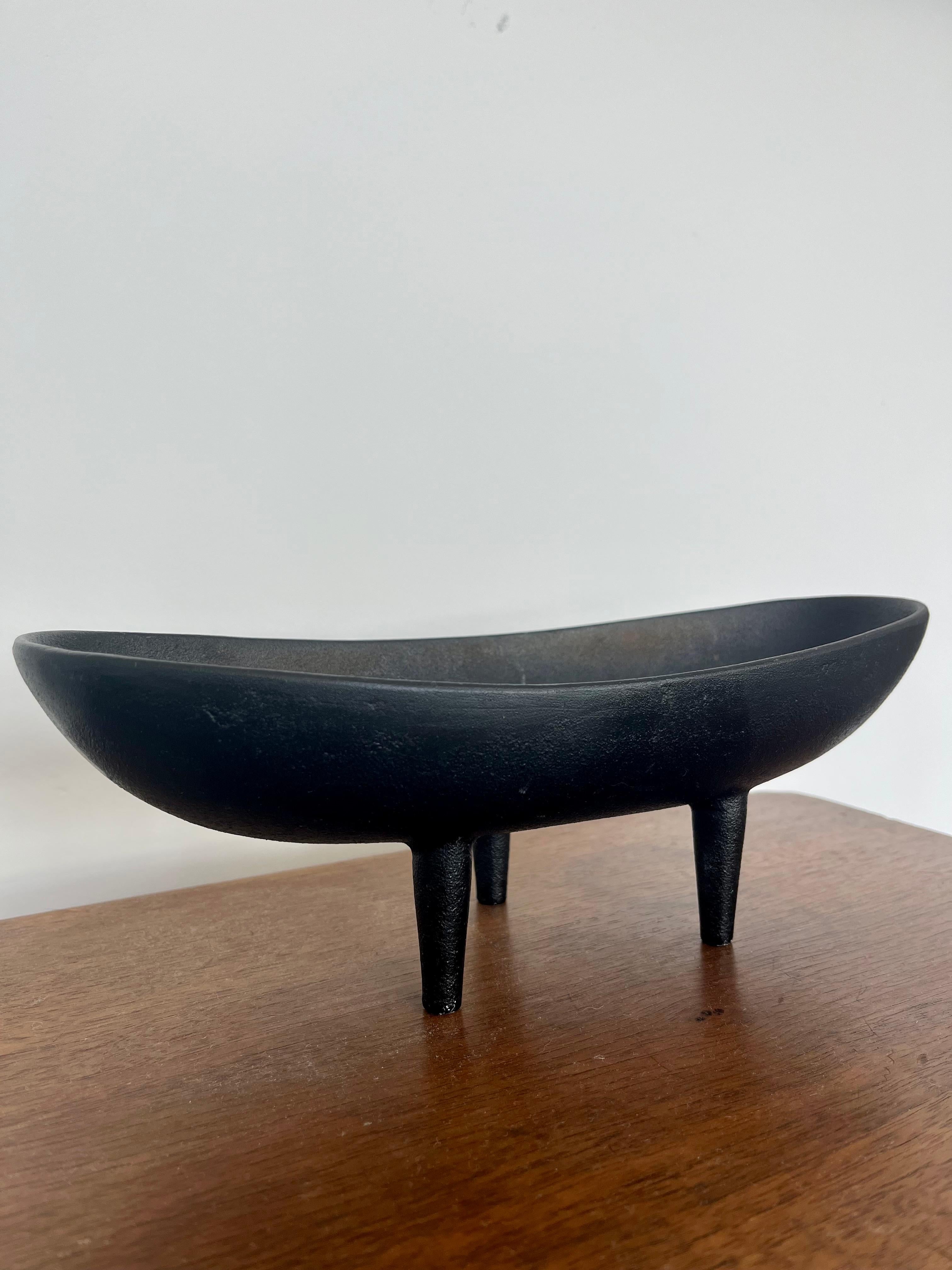 A cast iron three footed tripod bowl from Japan circa 1950s. similar to Isamu Noguchis designs for Bonniers. This would make a great centerpiece on a table or an accent piece on a shelf. 
Unmarked. 

Dimensions:
10.5