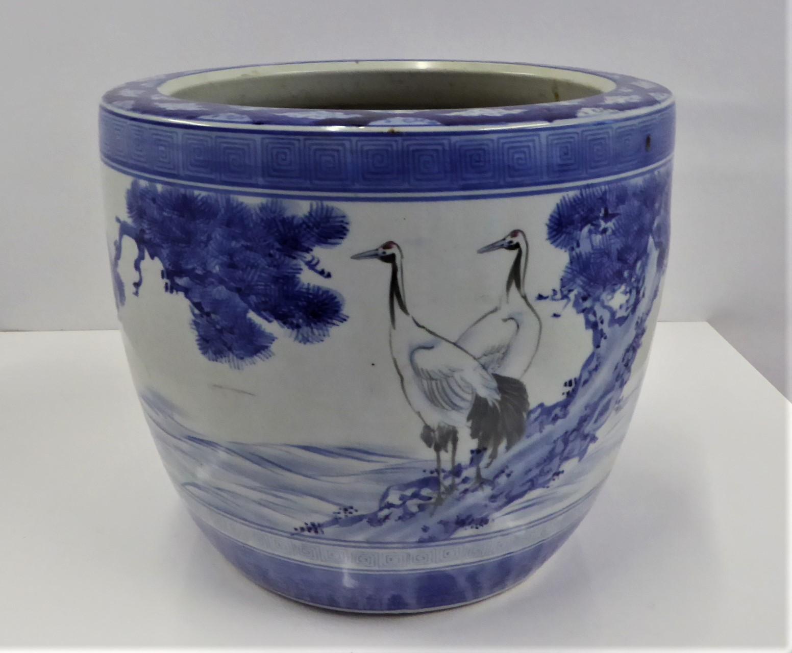 Lovely blue and white 1950s Japanese ceramic Hibachi with underglaze hand painted decoration of cranes, pine trees and mountains. The design is of 2 cranes perched on the trunk of a pine tree while another crane is in flight. Symbolism of Cranes -