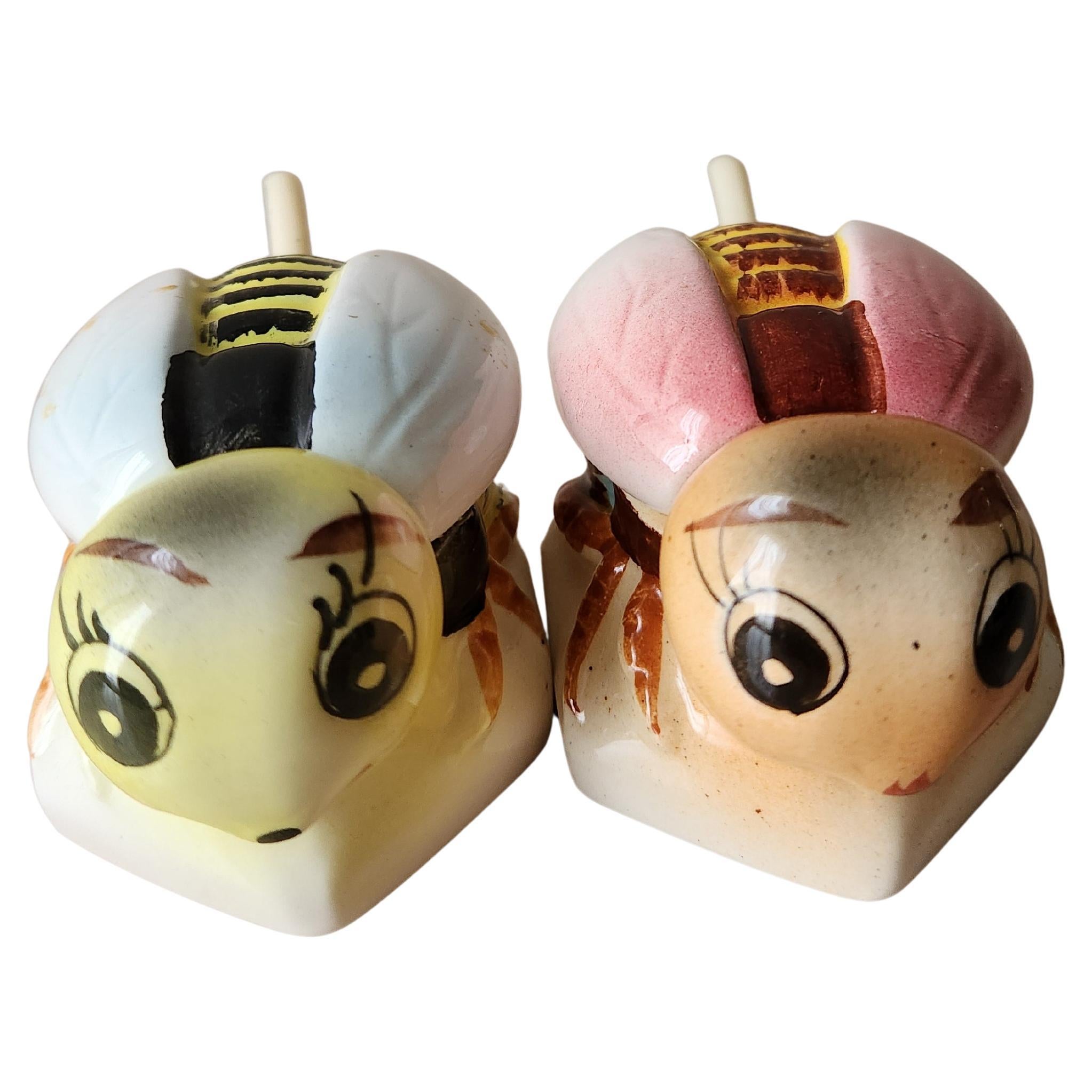 1950s Adorable set of 2 Bumble Bee Honey Pots each with original serving spoon
condiment server salt cellars jam spread spices
Ceramic Hand Painted Blue Pot and Pink Pot
2W × 2.5D × 1.75H
Made in Japan
Preowned original vintage condition