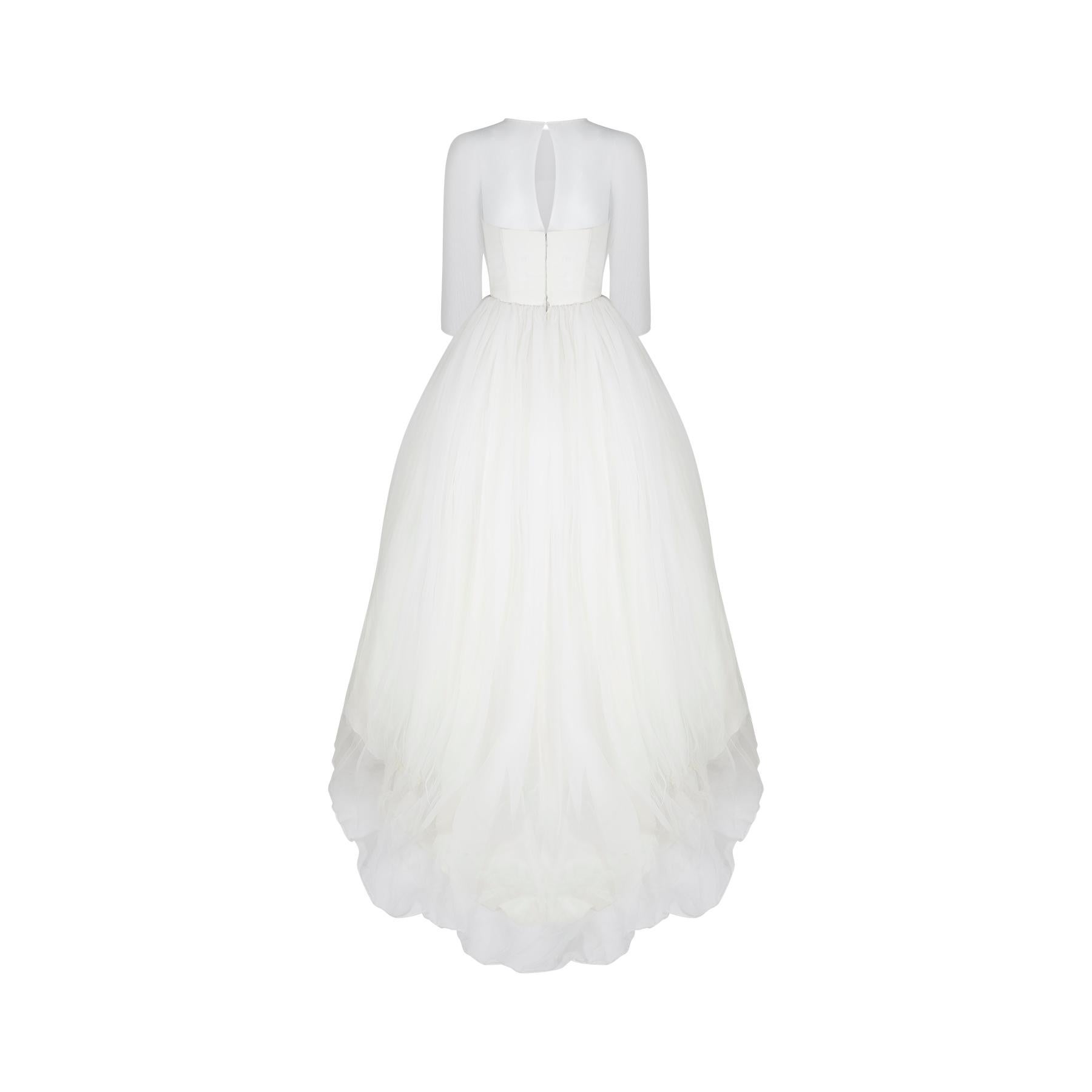 This late 1950s to early 1960s wedding dress is a rare thing.  It is the earliest wedding dress and indeed the earliest item we've ever seen from designer Jean Varon who founded his own label in 1959.  It is the classic archetypal layered wedding