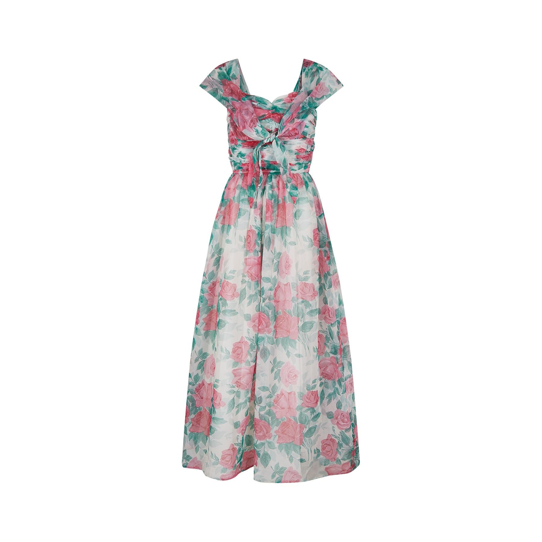 A very beautiful and romantic 1950s English rose print maxi dress. It has a ruched bodice with a sweetheart neckline which is gathered at the side seams.  There is an attached wide sailor collar that forms the shoulder straps.  Depending on how it