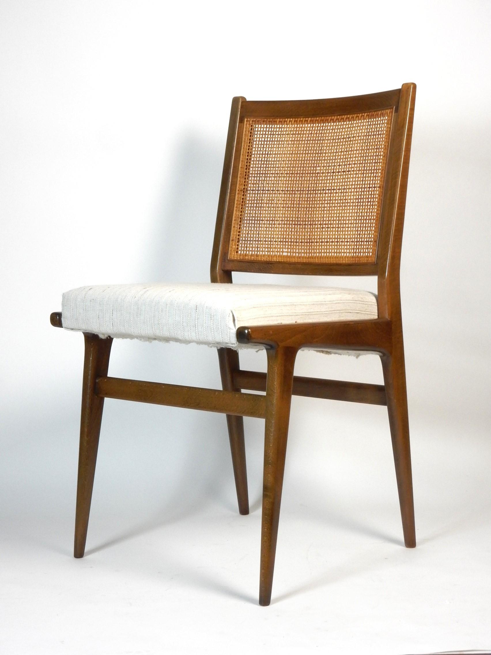 Beautiful pair of cane back dining chairs designed by Jens Rison for J.O. Carlssons Möbelindustri.
Completely original except for the seat covers. 
Well cared for as you can see in photos. 
A few small areas where the cane is chipped(pictured). Both