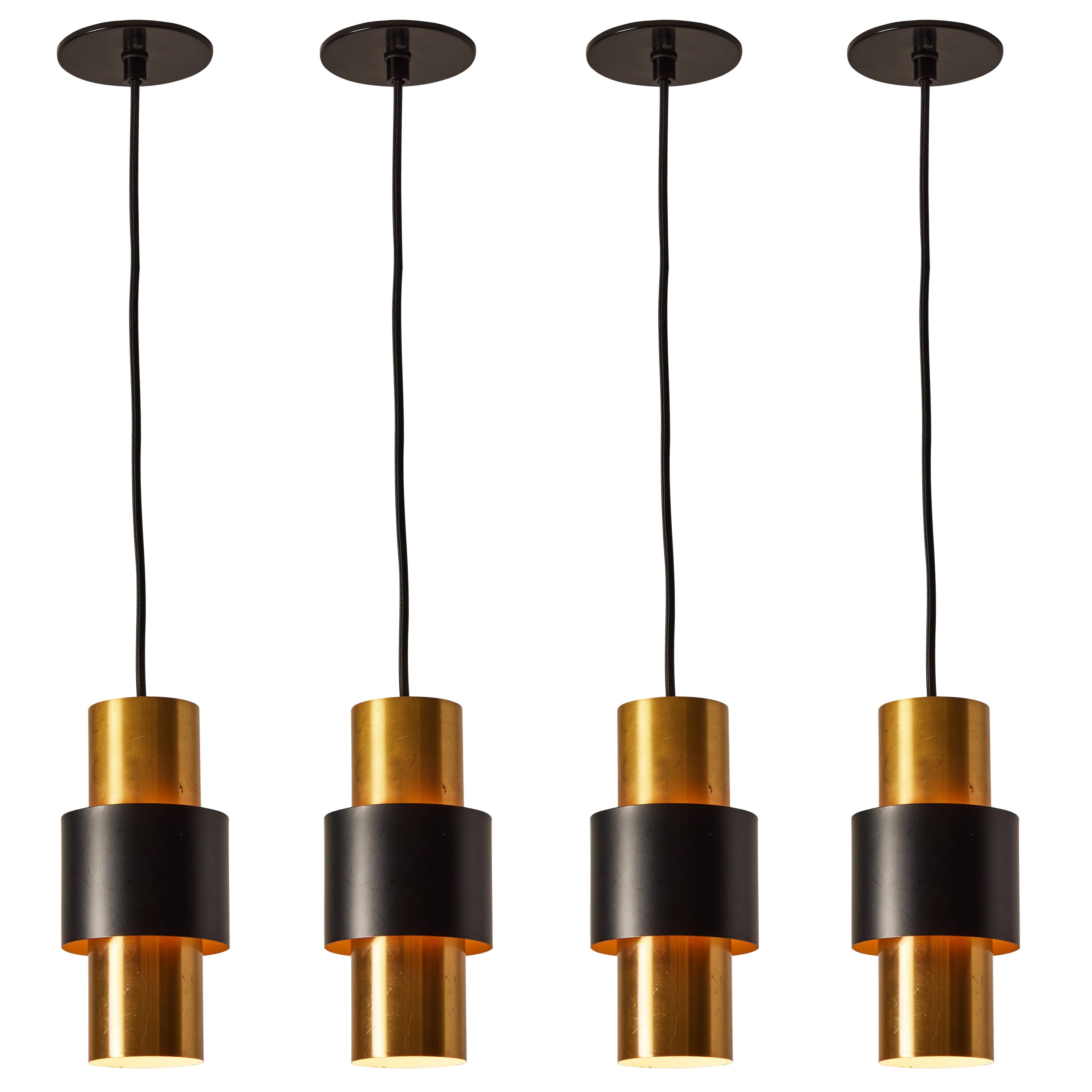 1950s Jo Hammerborg 'Saturn' brass & black pendant for Fog & Mørup. A Minimalist Danish modern design Classic executed in brass and black enameled metal. Body of lamp measures approximately 9.5 inches in height.

Fog and Mørup was one of the most