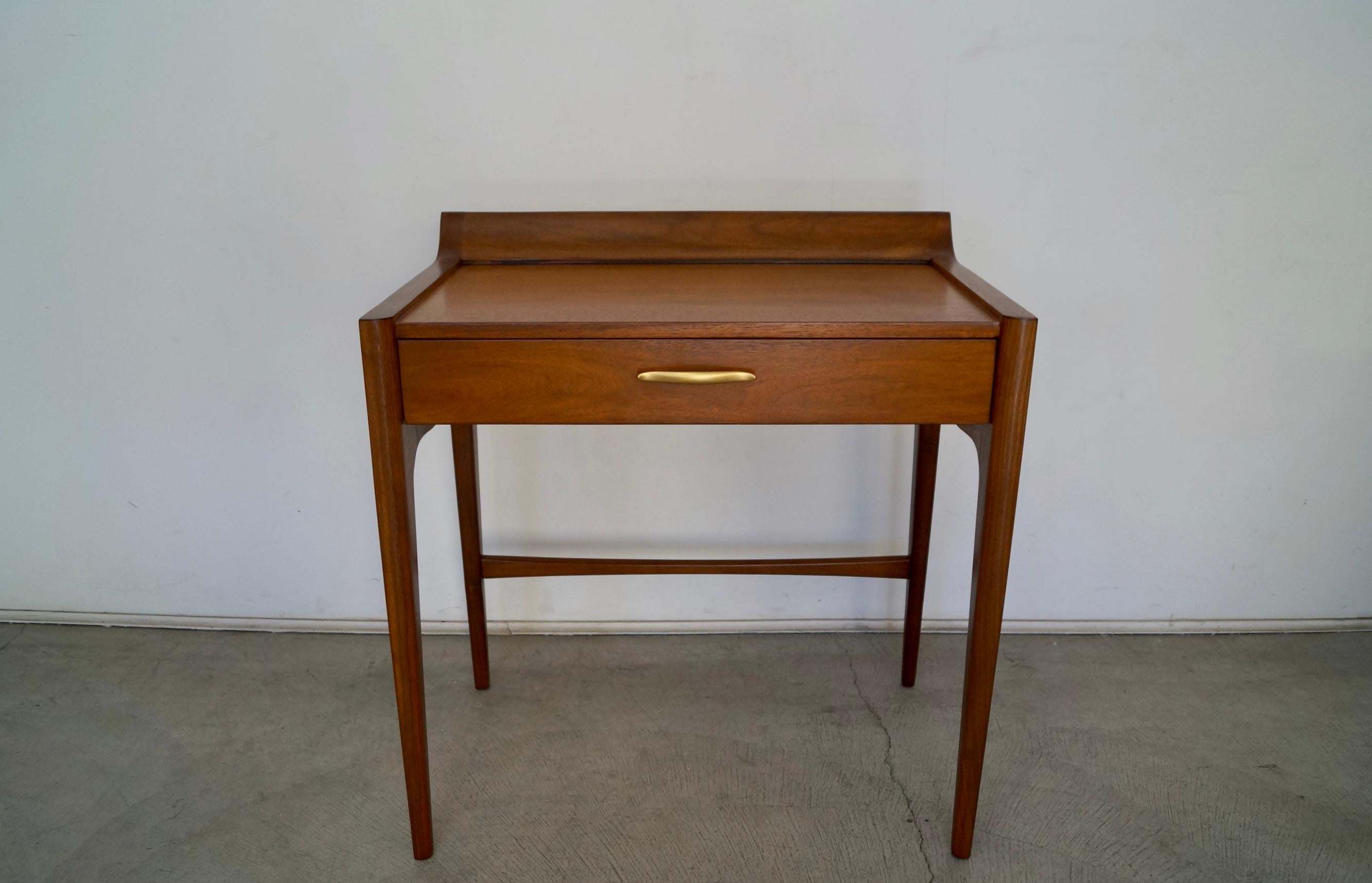 Vintage Mid-Century Modern vanity desk for sale. Designed by John Van Koert for Drexel in the 1950's, and part of the Profile series. This vanity desk is rare, and has been professionally refinished. It has a single drawer with the original pull