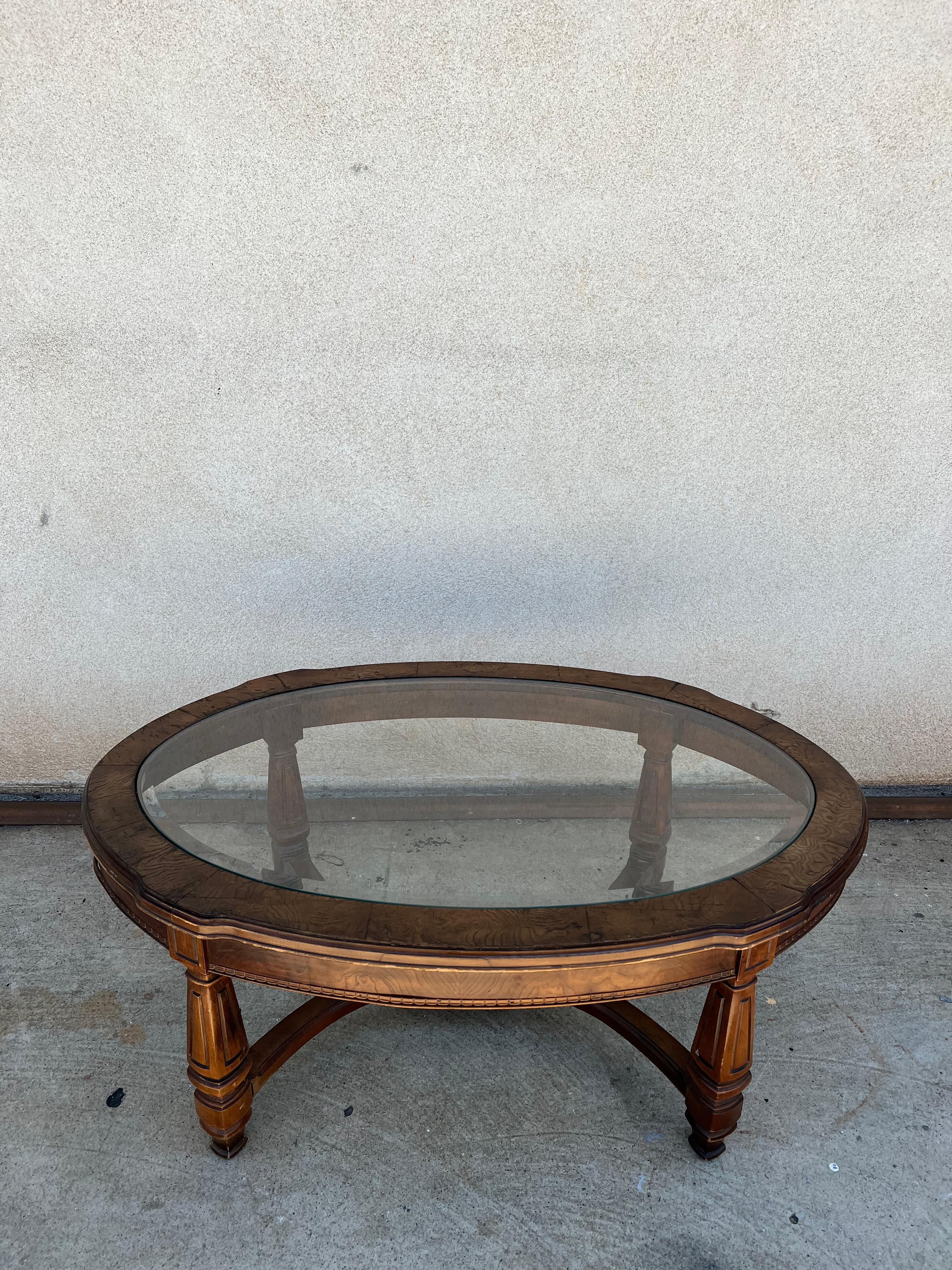 Vintage John Widdicomb  oval Burled Wood Coffee Table with Beveled Glass. 

A timeless piece by one of the most relevant designers of almost every style of furniture design capturing the pure essence of the era but still being able to combine his
