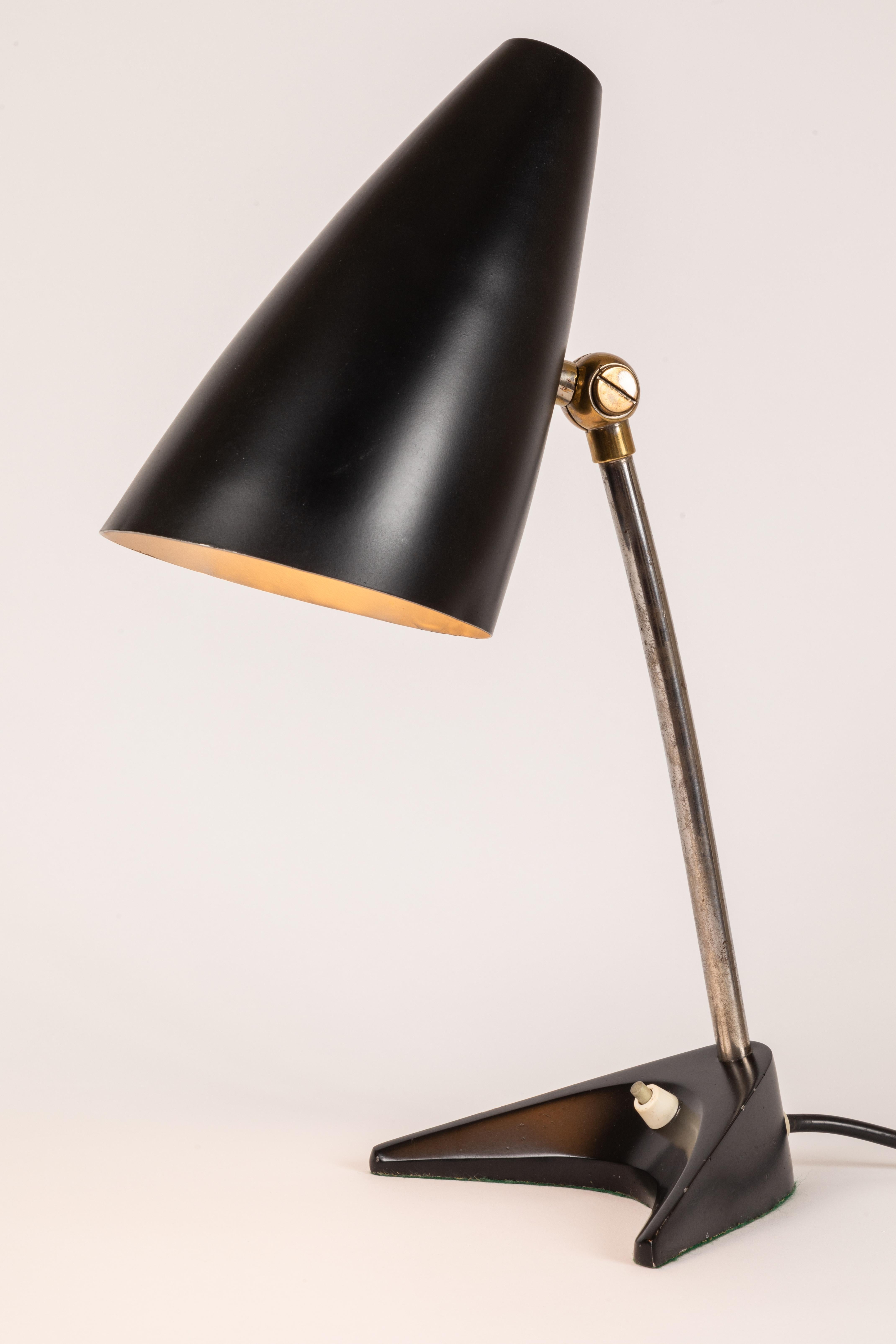 1950s J.T. Kalmar black table lamp. A beautiful and whimsical table lamp by Viennese design icon J.T. Kalmar from 1950s Austria. Executed in black painted metal shade adjusts up/down with original on/off switch in base.
 
Also available in gray in