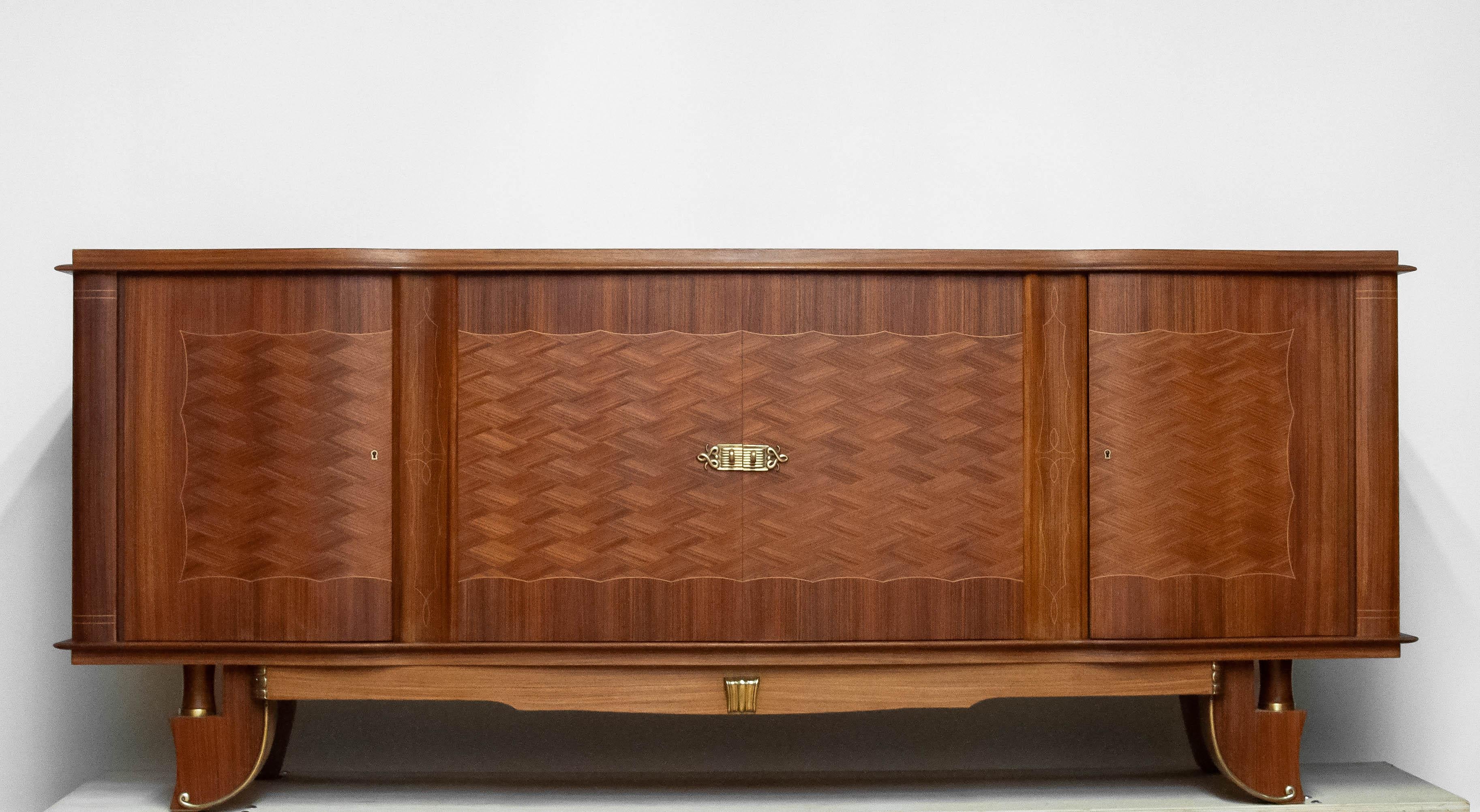 Beautiful quality product from the 1950s made in France by Jacques A. Gillen who had his workshop in Paris. Only the best quality wood has been used to complete this cabinet. The beautiful wooden inlay in the door panels makes this cabinet an