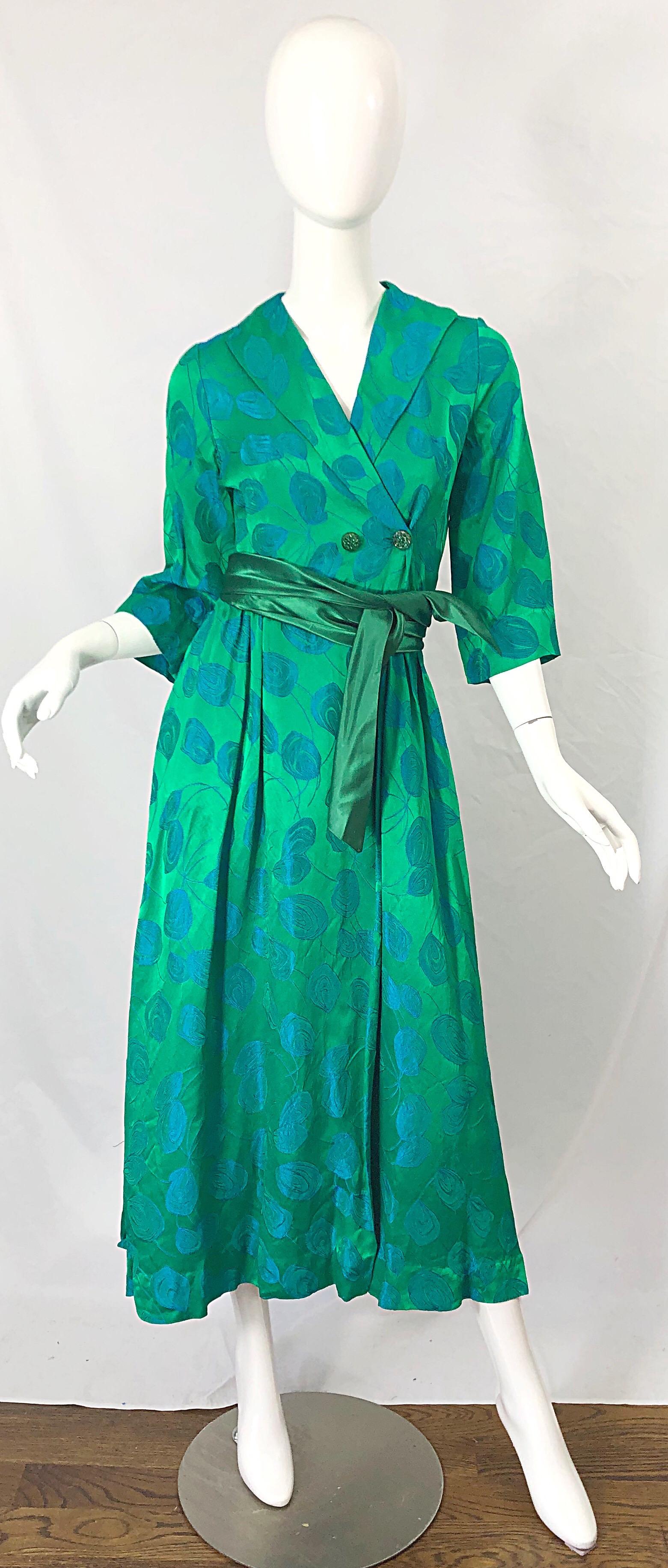 Beautiful vintage 1950s kelly green and blue flower print wrap dress ! Wrap style with interior ties and green rhinestone encrusted buttons. Shawl style collar. Long detachable silk belt. Blue abstract flowers printed throughout. Perfect for any day