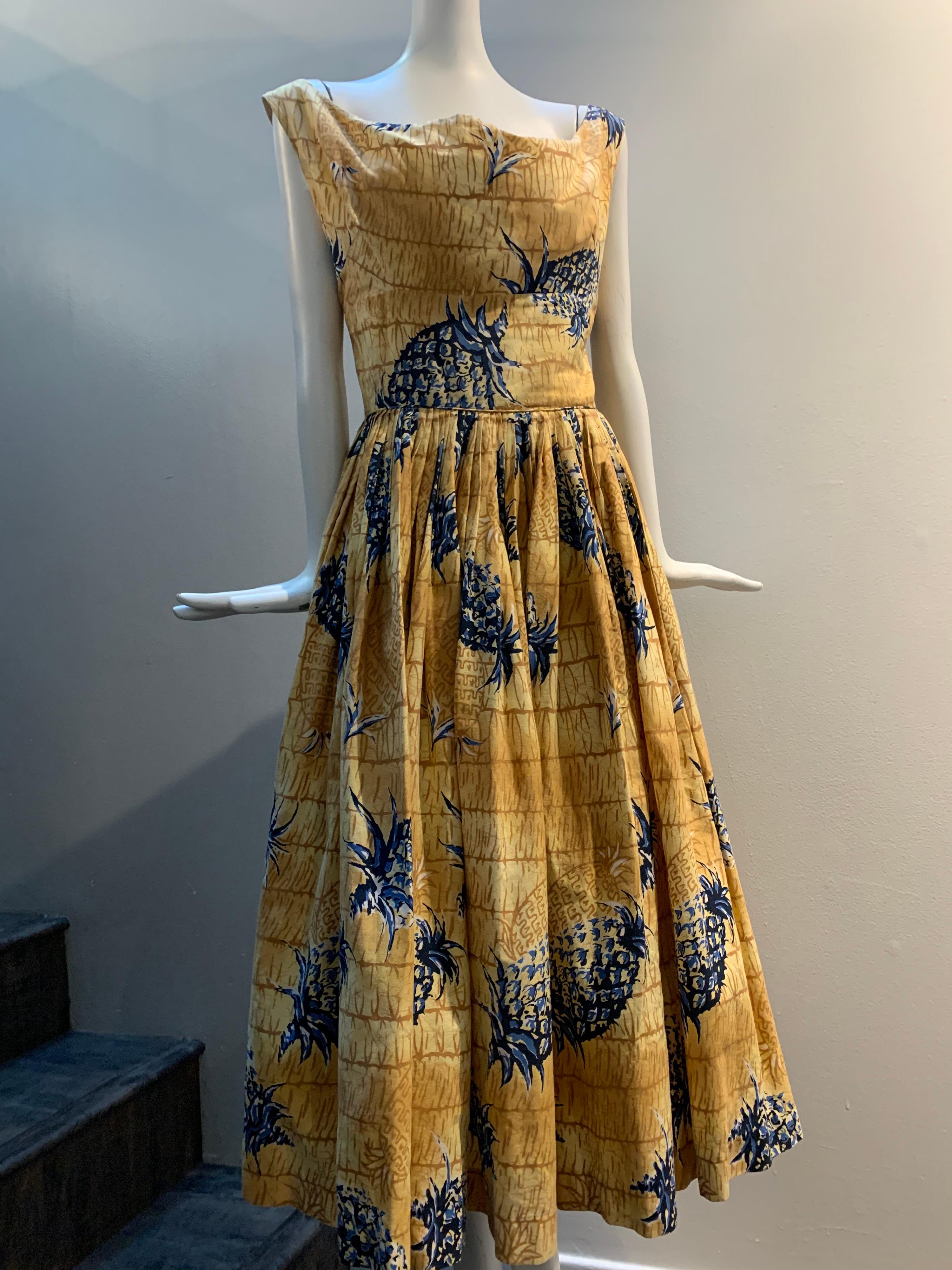 1950s Kiilani - Honolulu golden cotton sundress with blue and black pineapple print throughout on a thatched roof background. Zip back. Full skirt with deep pleating. Size 6 with full bust. 