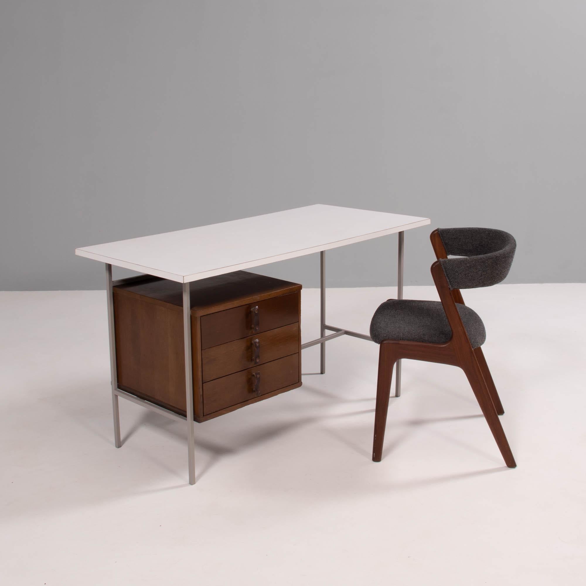 Designed and manufactured by Knoll & Drake, this 1950s desk is both practical and timeless.

Constructed with metal legs, the desk has a white Formica table top and single walnut wood pedestal.

Three drawers offer plenty of storage and are