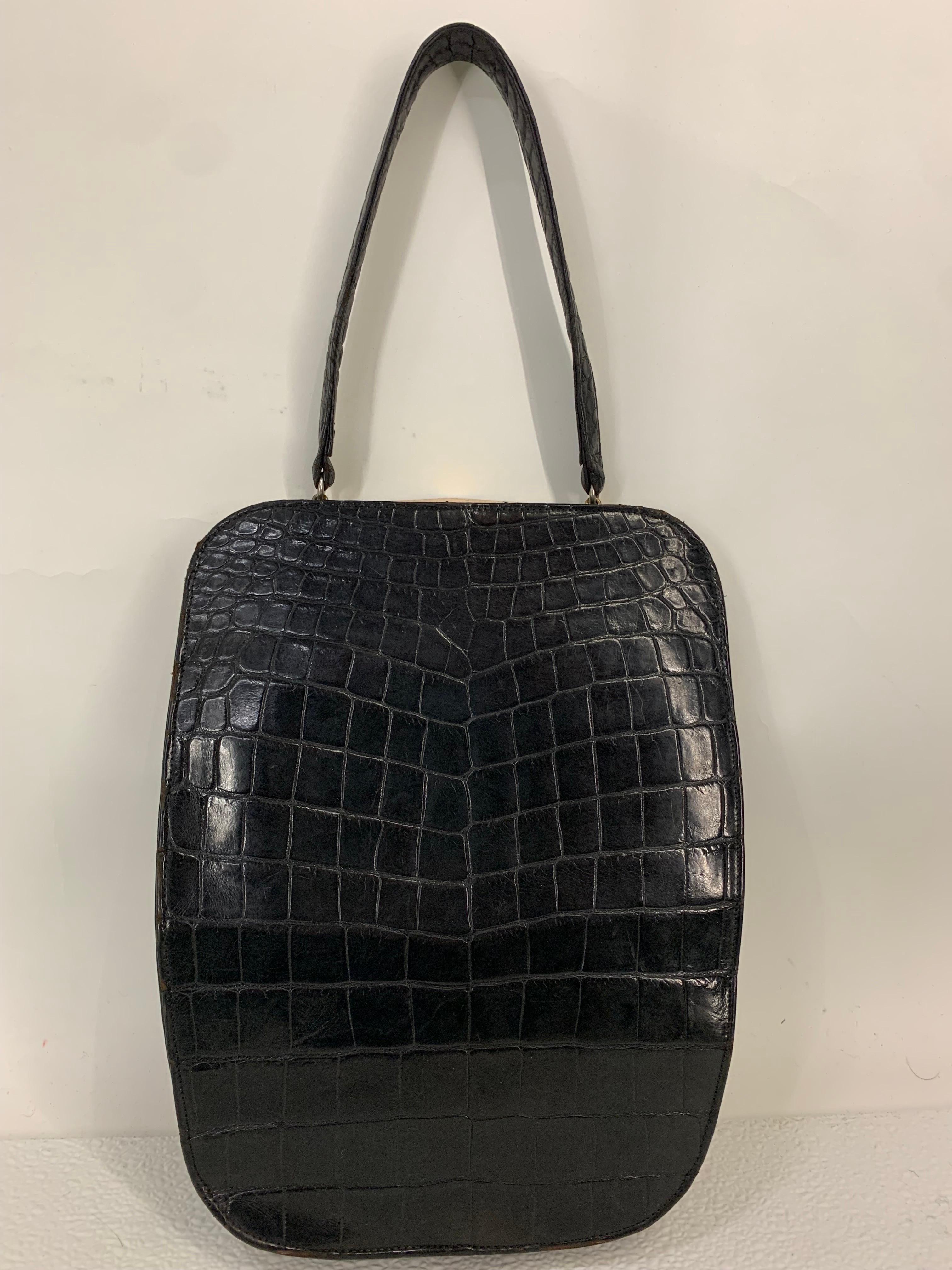 1950s Koret Genuine Black Alligator Handbag w Rare & Unusual Asymmetrical Closure. Inner lining and original coin purse is Koret signature red leather.  Upper right hand corner is cut away in tiers to expose gold-tone frame of bag. Super cute,