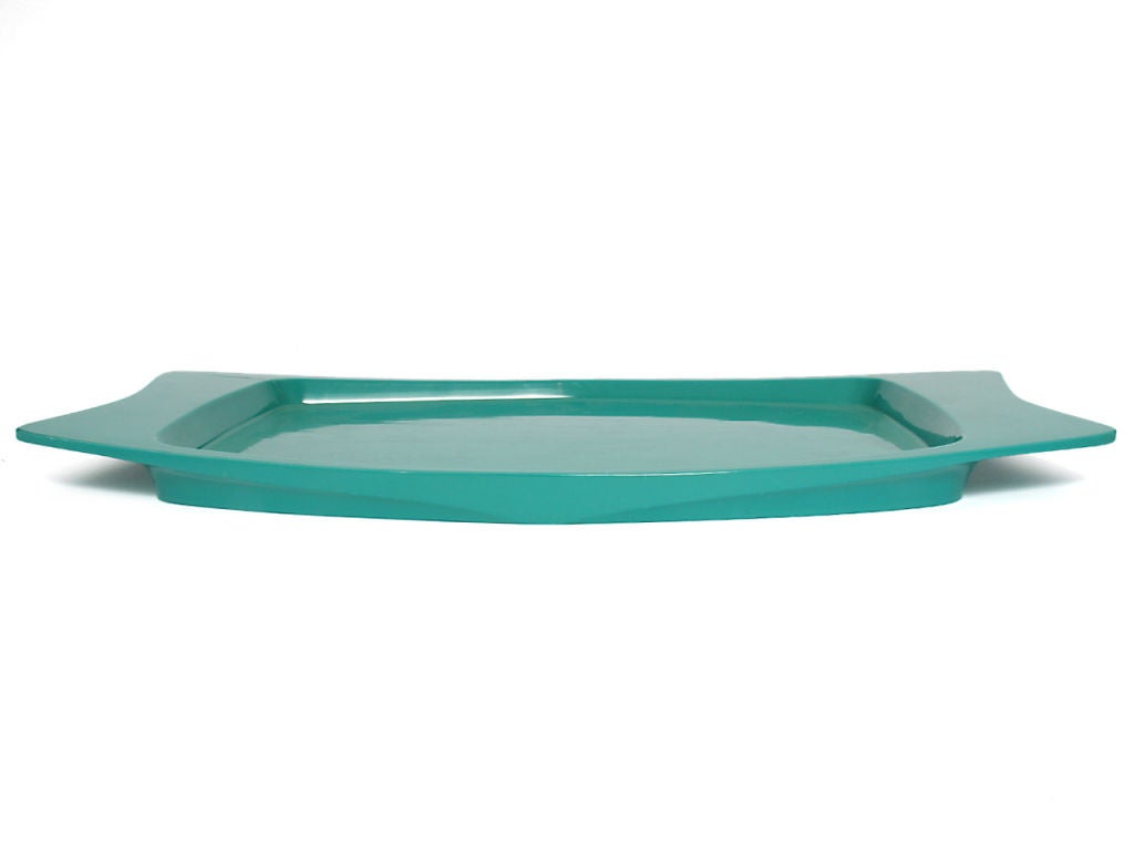 A turquoise lacquered wood tray with broad, indented handles.