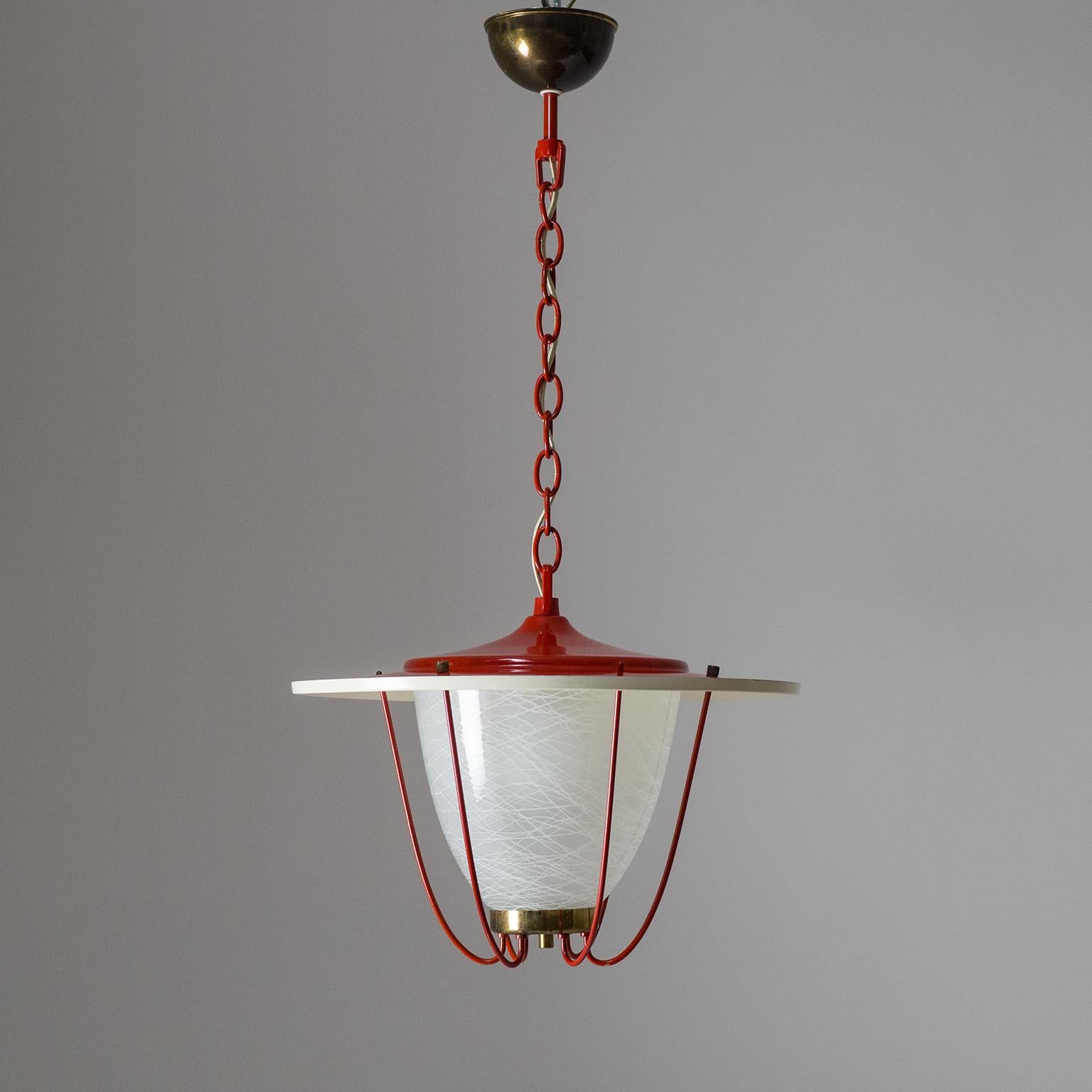 Delightful colorful midcentury lantern from the 1950s. The large shade is lacquered off-white on the inside and glossy red on the outside, the chain and the brass shade supports are lacquered in the same red, all in fine original condition save for
