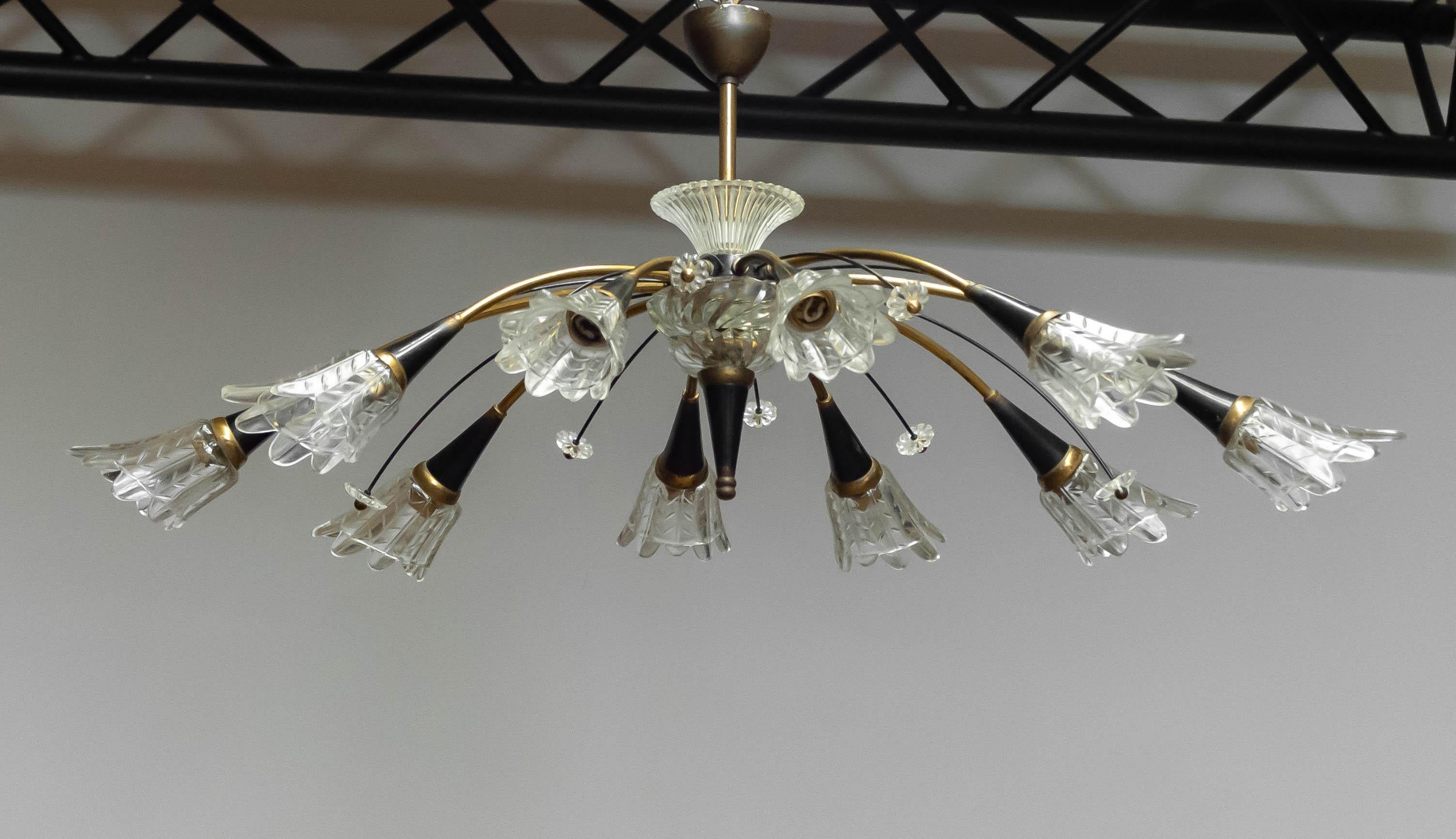Beautiful large 'oval' chandelier / flush mount with ten armes all with the original B22 fittings in black metal, brass and glass shades. This chandelier is made in the 1950's by Maison Lunel in Paris France and is in allover good condition.
The