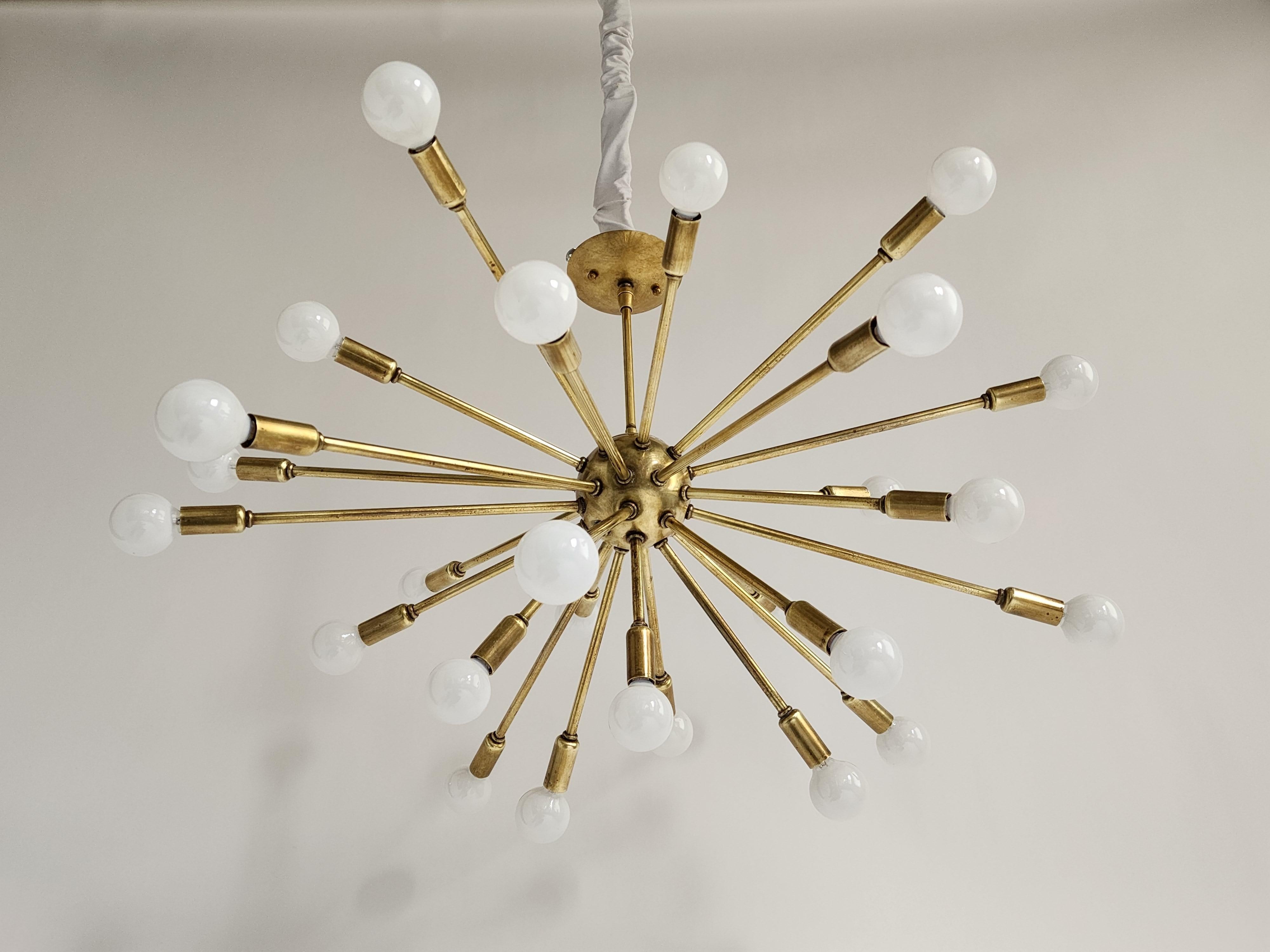 Genuine 1950s Sputnik with a bold personality and a lot of presence. 

26 arms of different lenght create this chandelier burst in all direction. 

Solid, well made structure and construction. 

26 Candelabra E12 sockets rated at 25 watts.