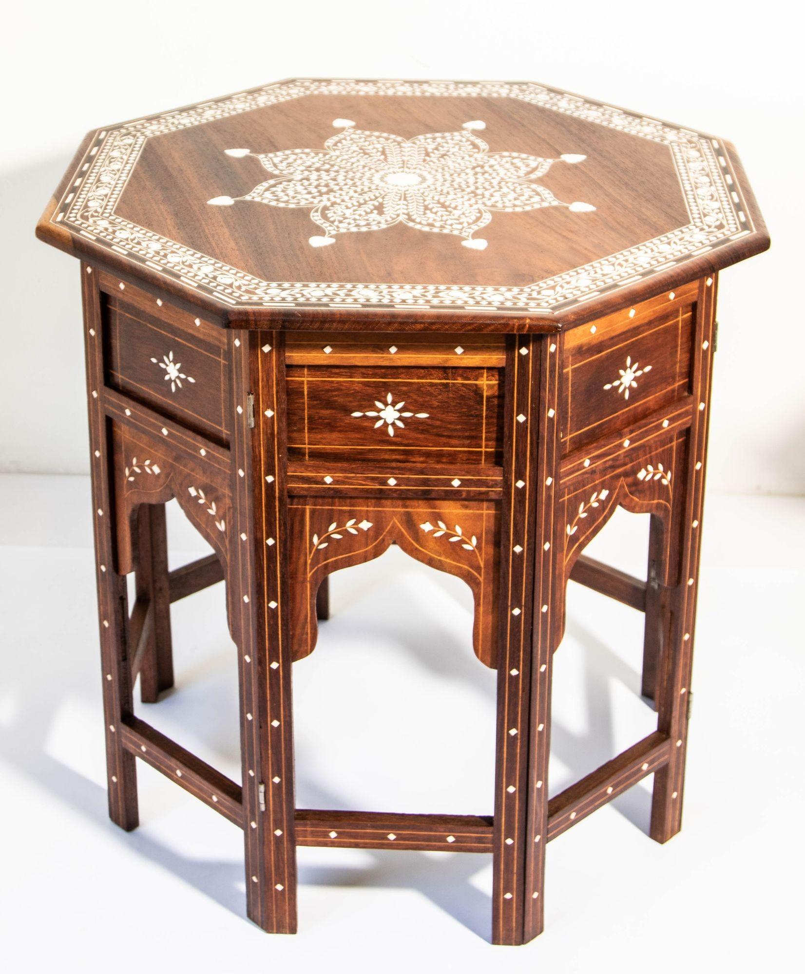 1950s Large and Intricately Bone Inlaid Anglo Indian Octagonal Side Table.
Originally used as traveling tea tables for the British in India, the octagonal top with central medallion surrounded stylized foliate designs within a border of meandering