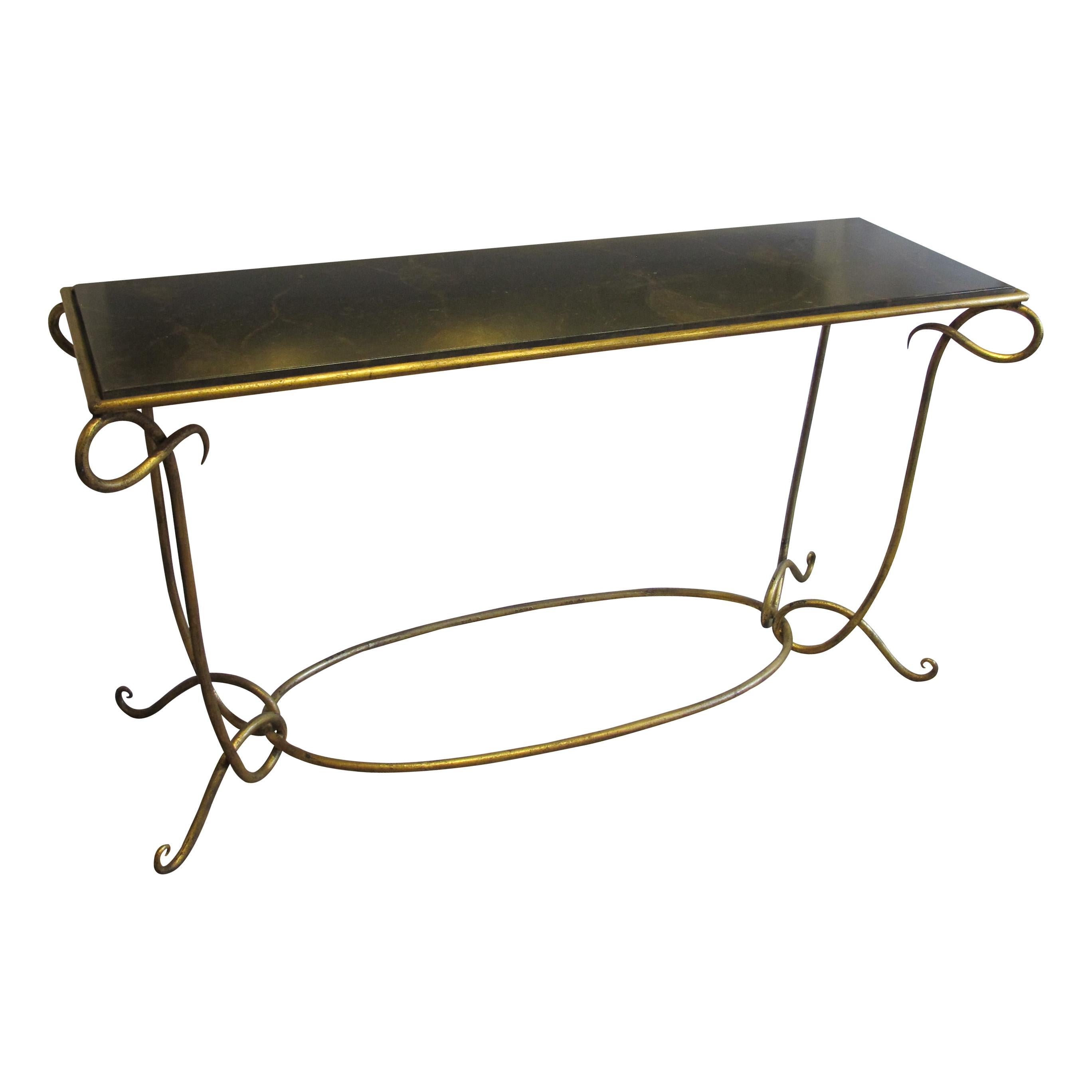 An elegant 1950s large console table with a gilt wrought iron frame. The console is made in the style of René Drouet known for his wrought iron furniture design. 
The console boasts generous curves and the top is made of painted wood. 

Size: H: 83