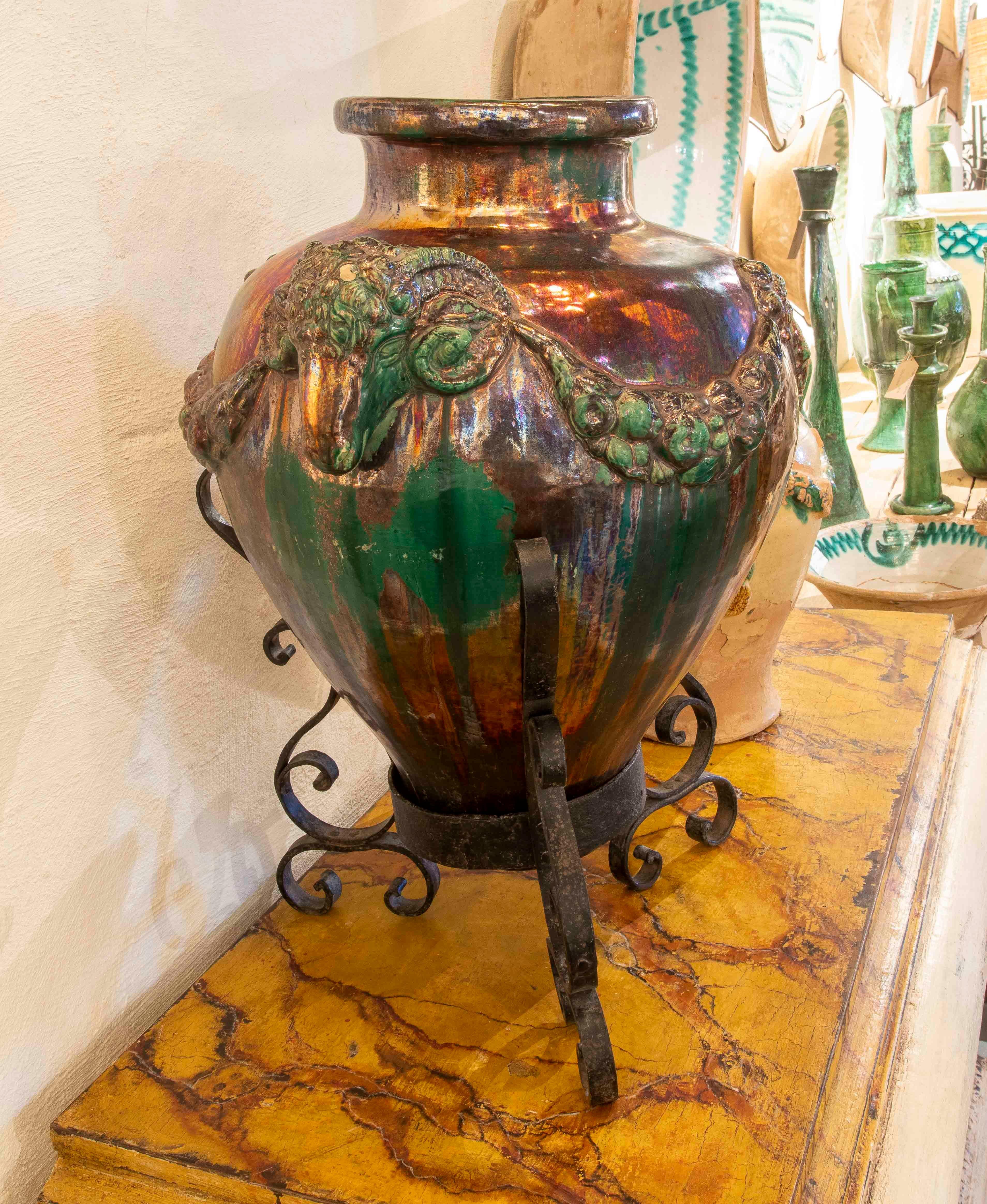 European 1950s Large Glazed Ceramic Vase with Ram Heads and Wrought Iron Base For Sale