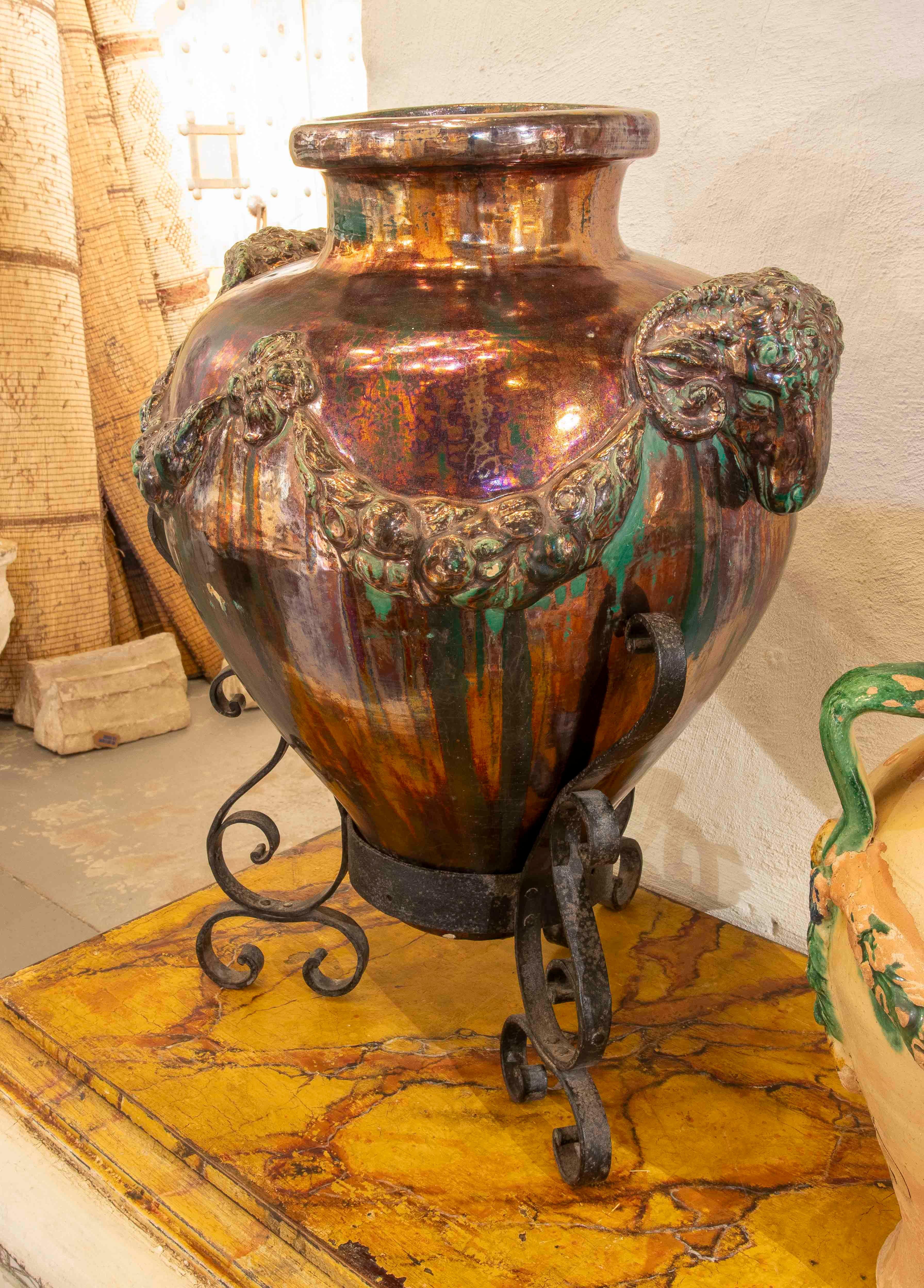 20th Century 1950s Large Glazed Ceramic Vase with Ram Heads and Wrought Iron Base For Sale