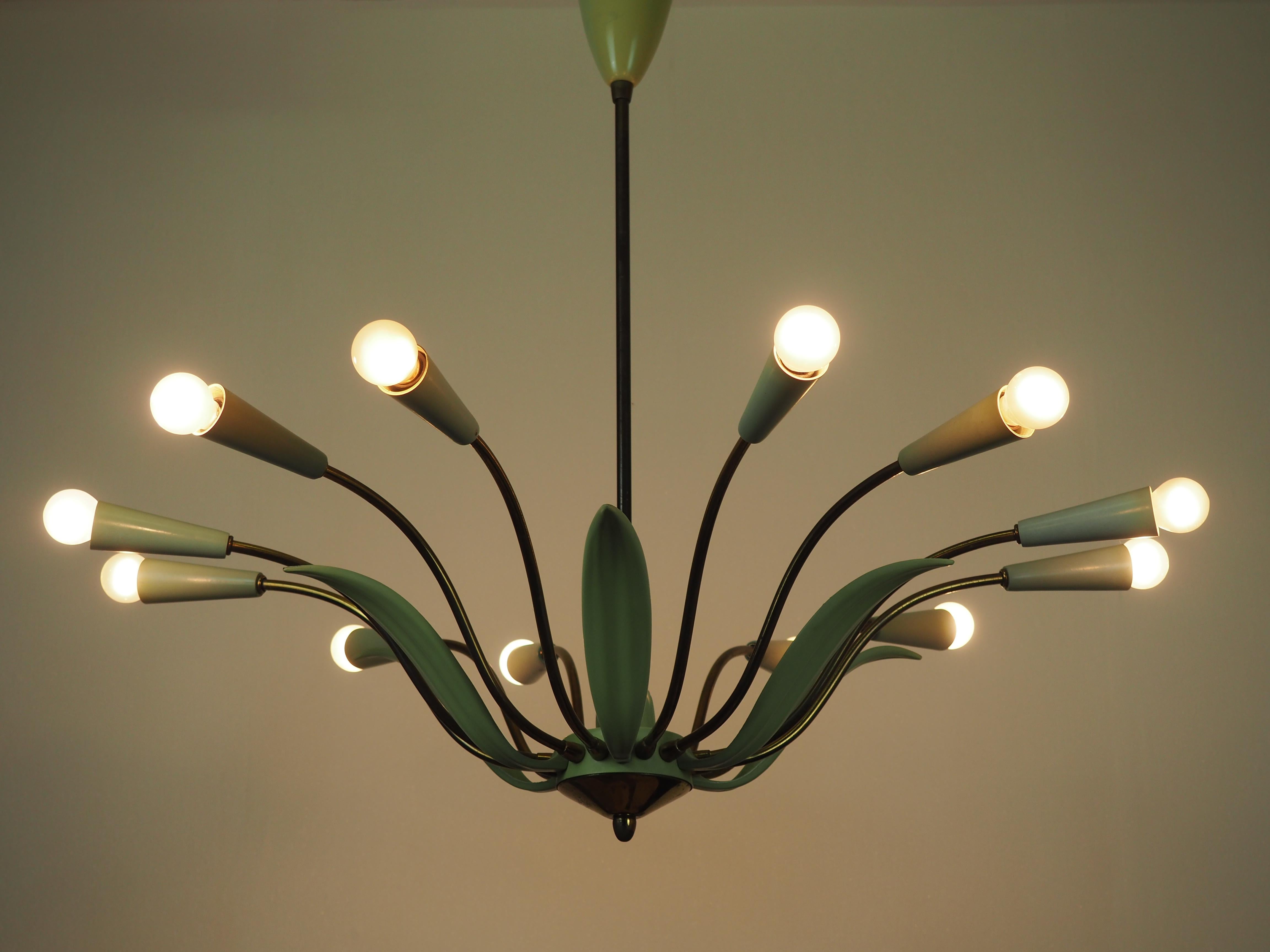 A large twelve-light midcentury Stilnovo style brass Sputnik chandelier.
This beautiful high quality chandelier is made of green enameled and patinated brass and plastic caps for twelve e14 standard screw bulbs.




  