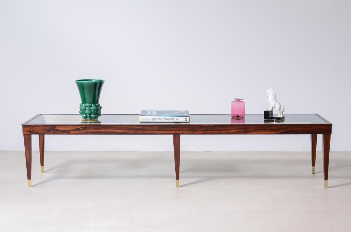 COD-2836
Large low coffee table with six elegant legs with bronze casting tips, thick cut glass top and gilded wood step molding inside the bands.

Italian manufacture ca. 1950.