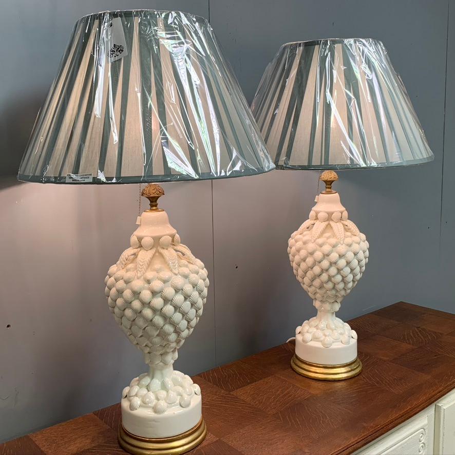 Spectacular and generously proportioned pair of Spanish ceramic table lamps of a bulbous form adorned with shells and leaves, standing on gilded bases, by the prestigious ceramic house 