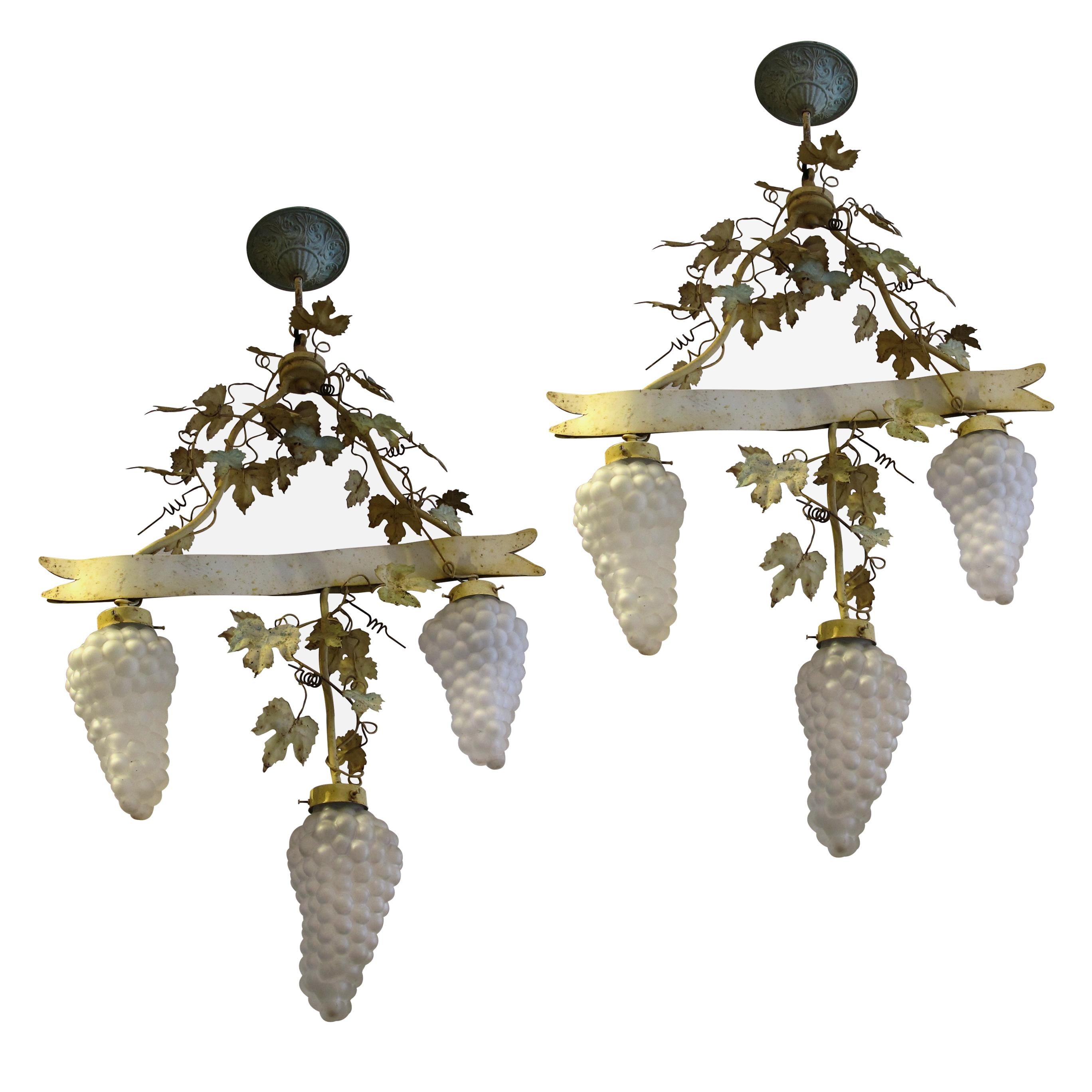 Highly decorative mid-century French pair of toleware hanging lights with foliage and grapevine-shaped glass shade. The lamps have acquired a beautiful patina over the years, their organic look will be ideal for a cellar or a conservatory. The
