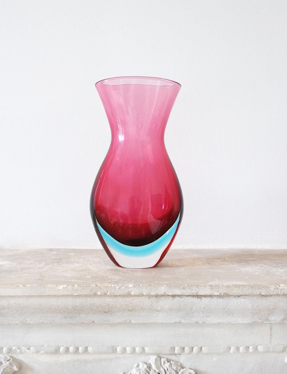 Wonderful very large heavy based pink Italian 'sommerso' vase found in Milan. This 1950s hand-blown Murano glass collectors piece is pink glass submerged with a line of aqua and ensconced in a clear glass base. It has a wonderful form and size and