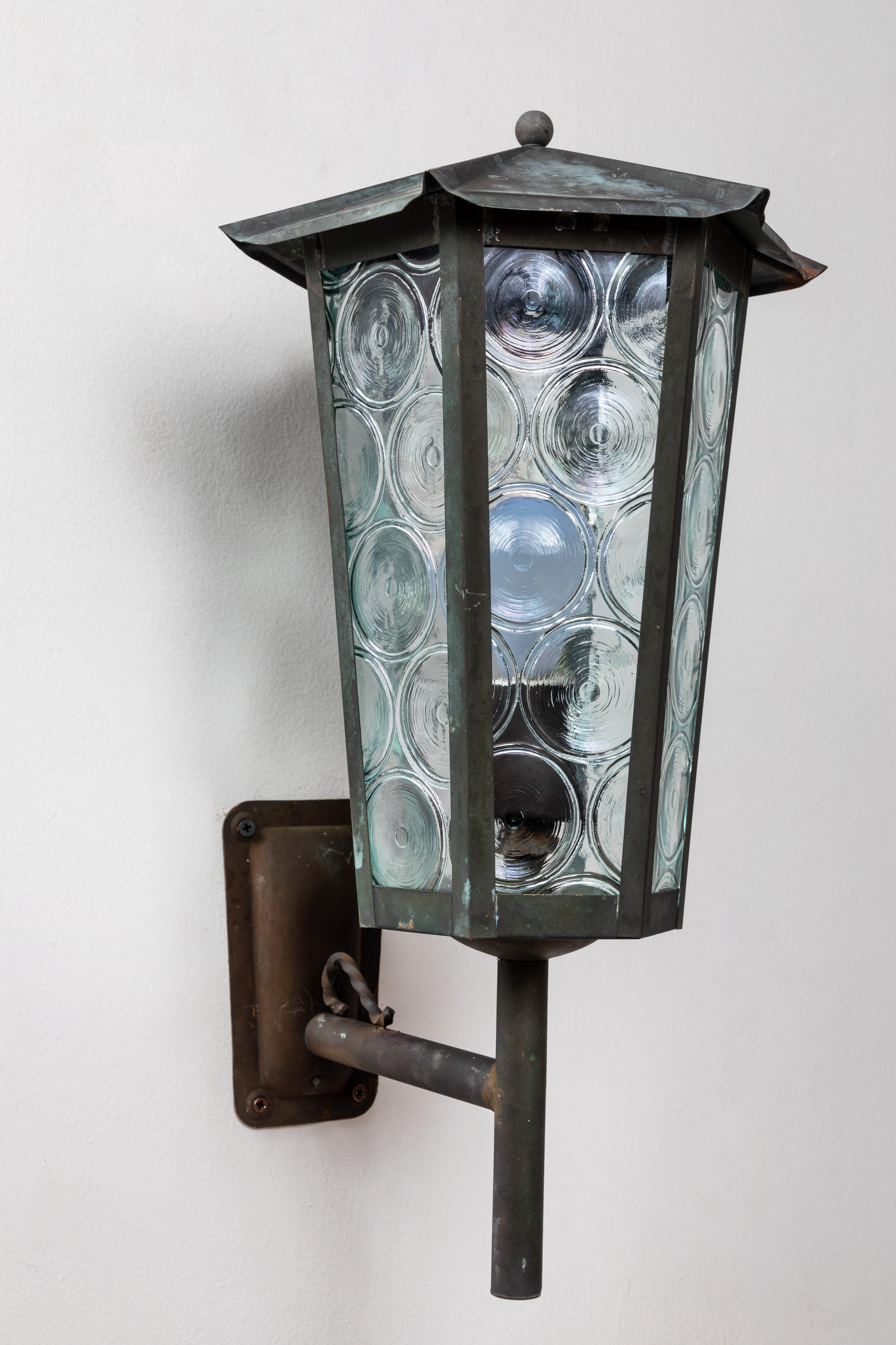 1950s Scandinavian outdoor wall lights in patinated copper and glass. Designer unknown. Executed in richly patinated copper and opaque green bottle glass. A highly sculptural design, these outdoor or indoor wall lights exude Scandinavian refinement