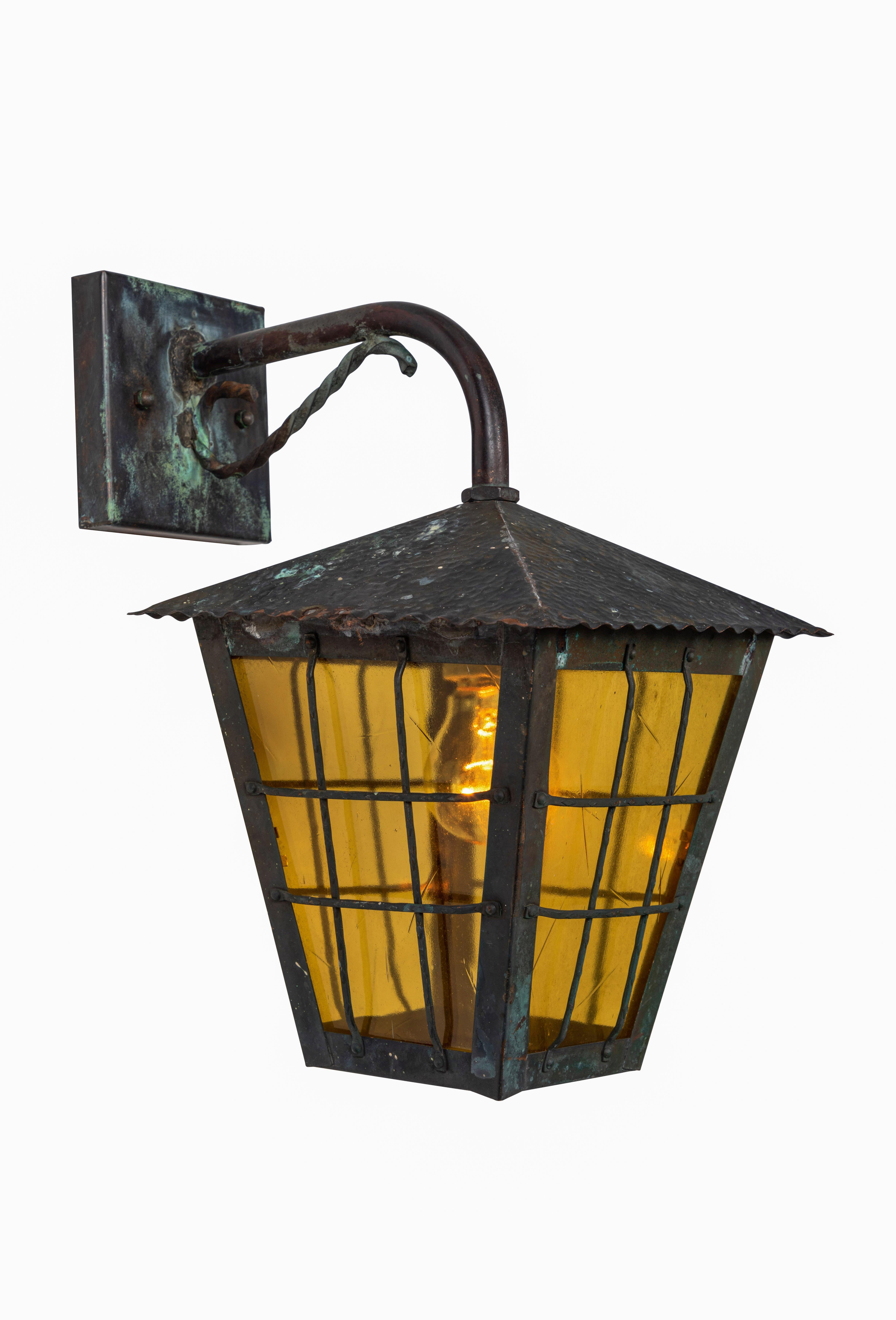 1950s Scandinavian outdoor wall lights in patinated copper and yellow glass. Designer unknown. Executed in richly patinated copper and yellow crackled glass. A highly sculptural design, these outdoor or indoor wall lights exude Classic influences