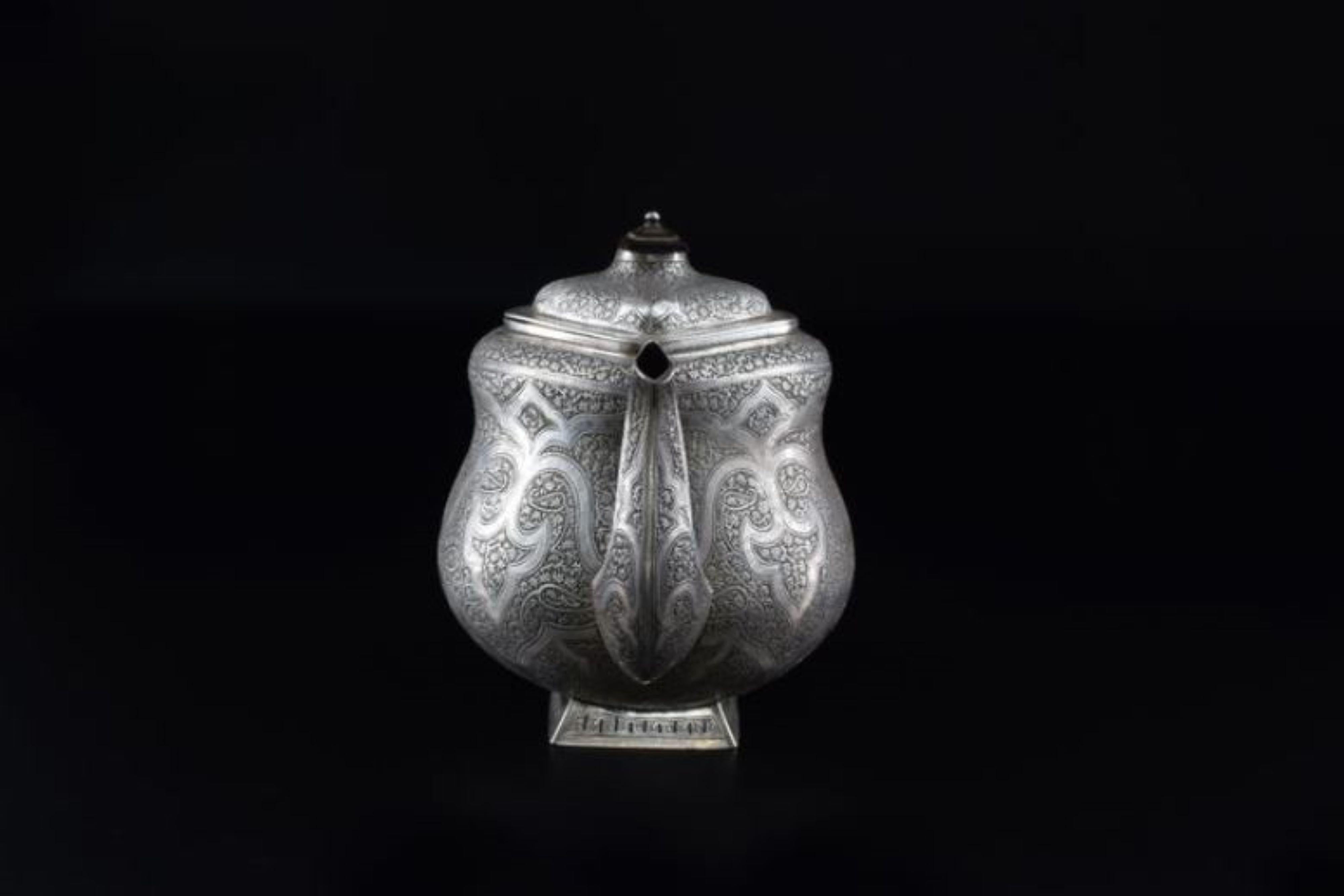 A handcrafted Moorish sterling silver teapot handcrafted in the 1950s. Its wooden handle, meticulously sculpted, complements the silver. What truly sets this piece apart are the intricate engraved Moorish patterns.

Weighing 766g, this teapot is