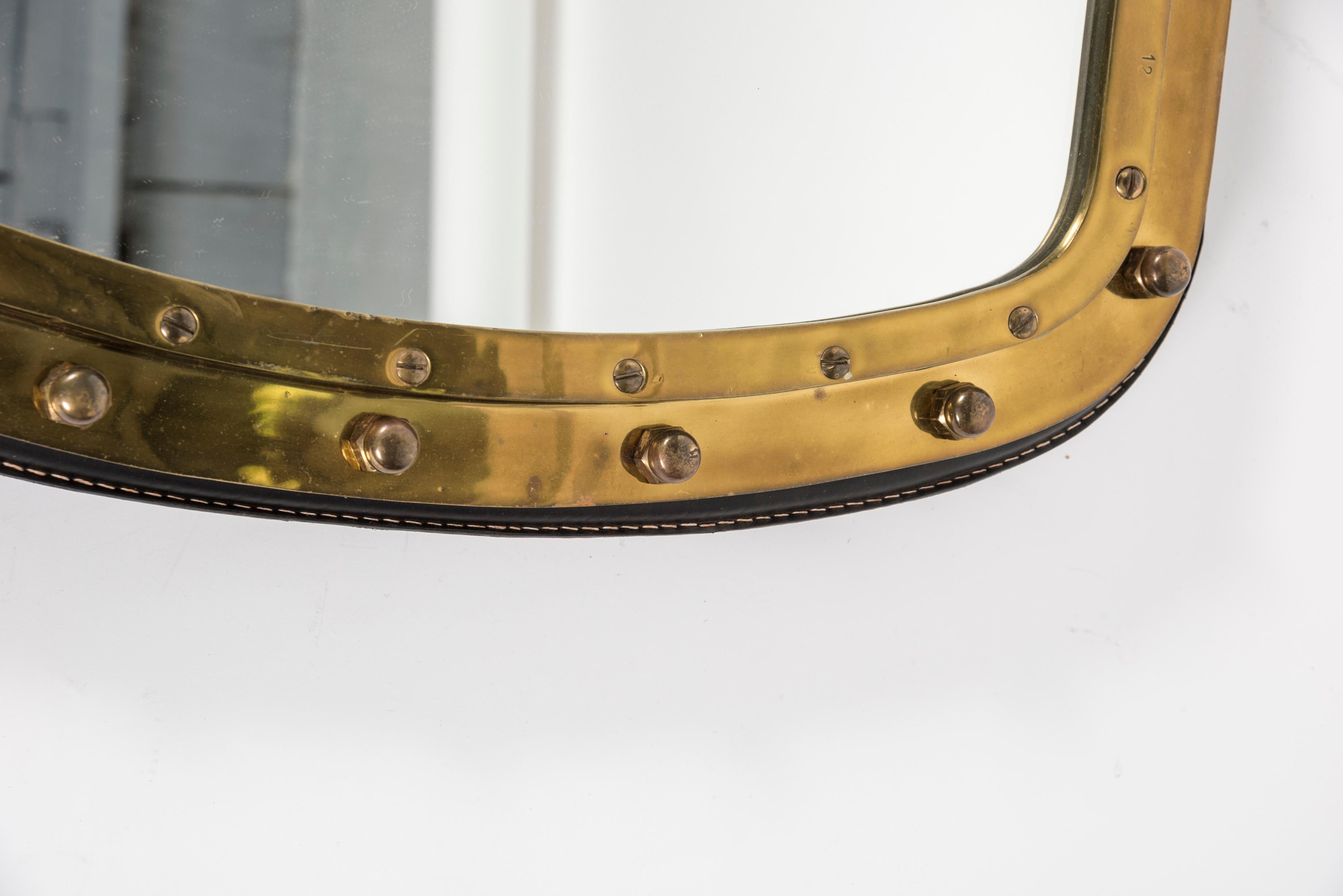 Bronze 1950s Large wall mirror in stitched leather and bronze by Jacques Adnet
