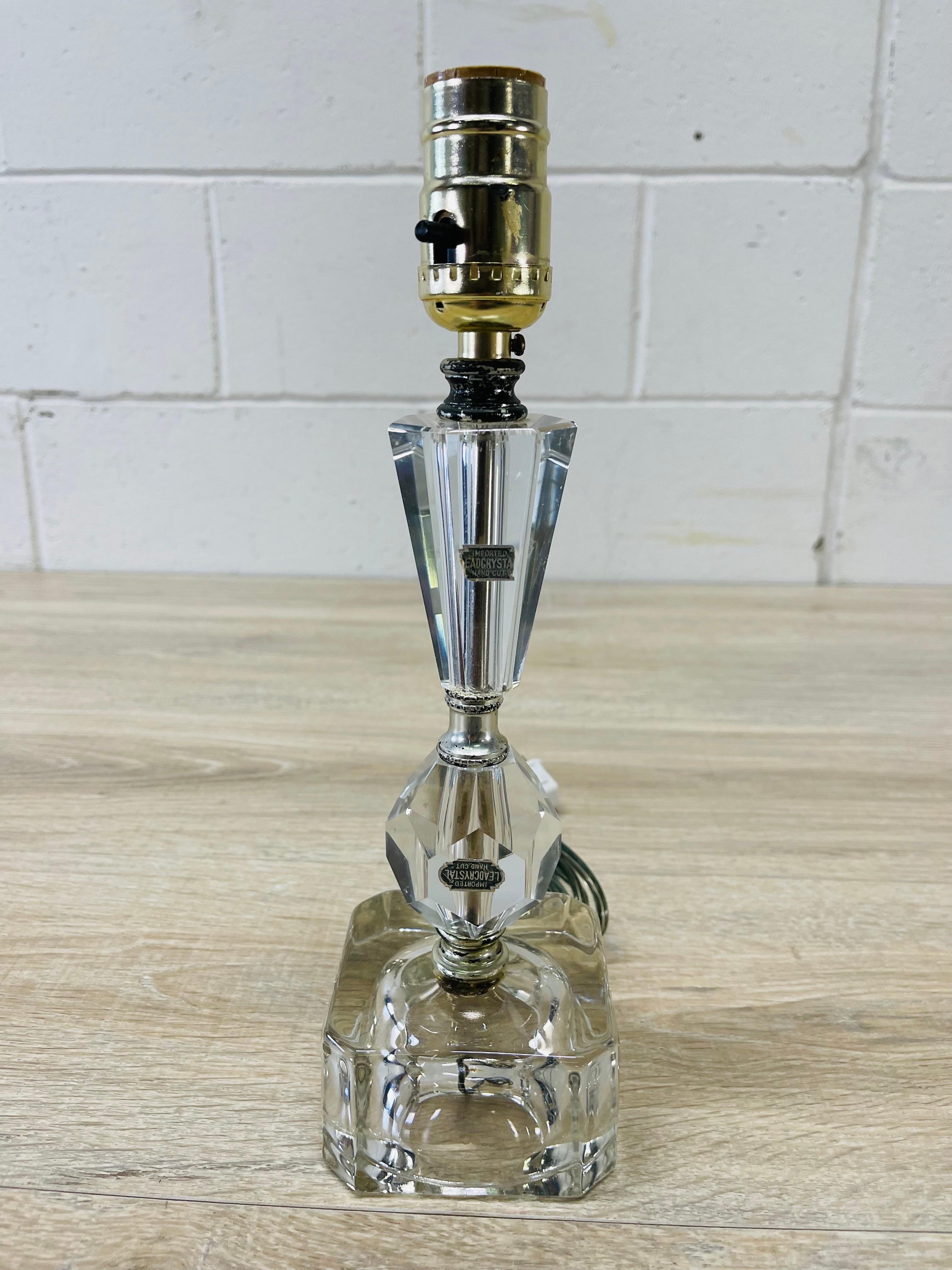 Vintage 1950s lead crystal table lamp. Wired for the US and in working condition. Uses a standard 75W bulb. Marked with a label.