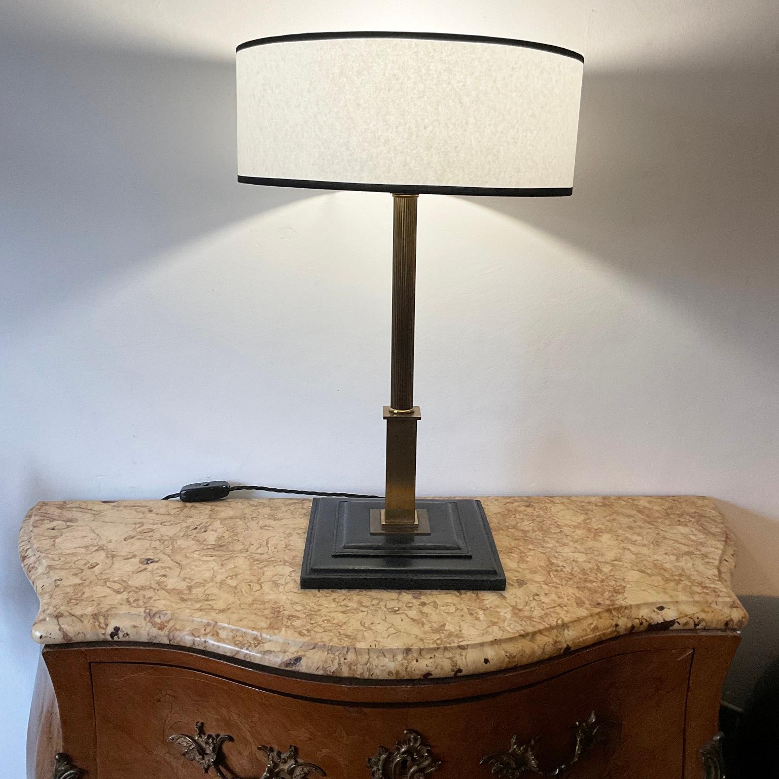 1950s Neoclassical table lamp in the Maison Longchamp or Hermes style.
Brass body with black full-grain saddle stitch leather base.
included a parchment lampshade with black fabric binding.
Rewired with insulated fabric cable and manual switch
Shade