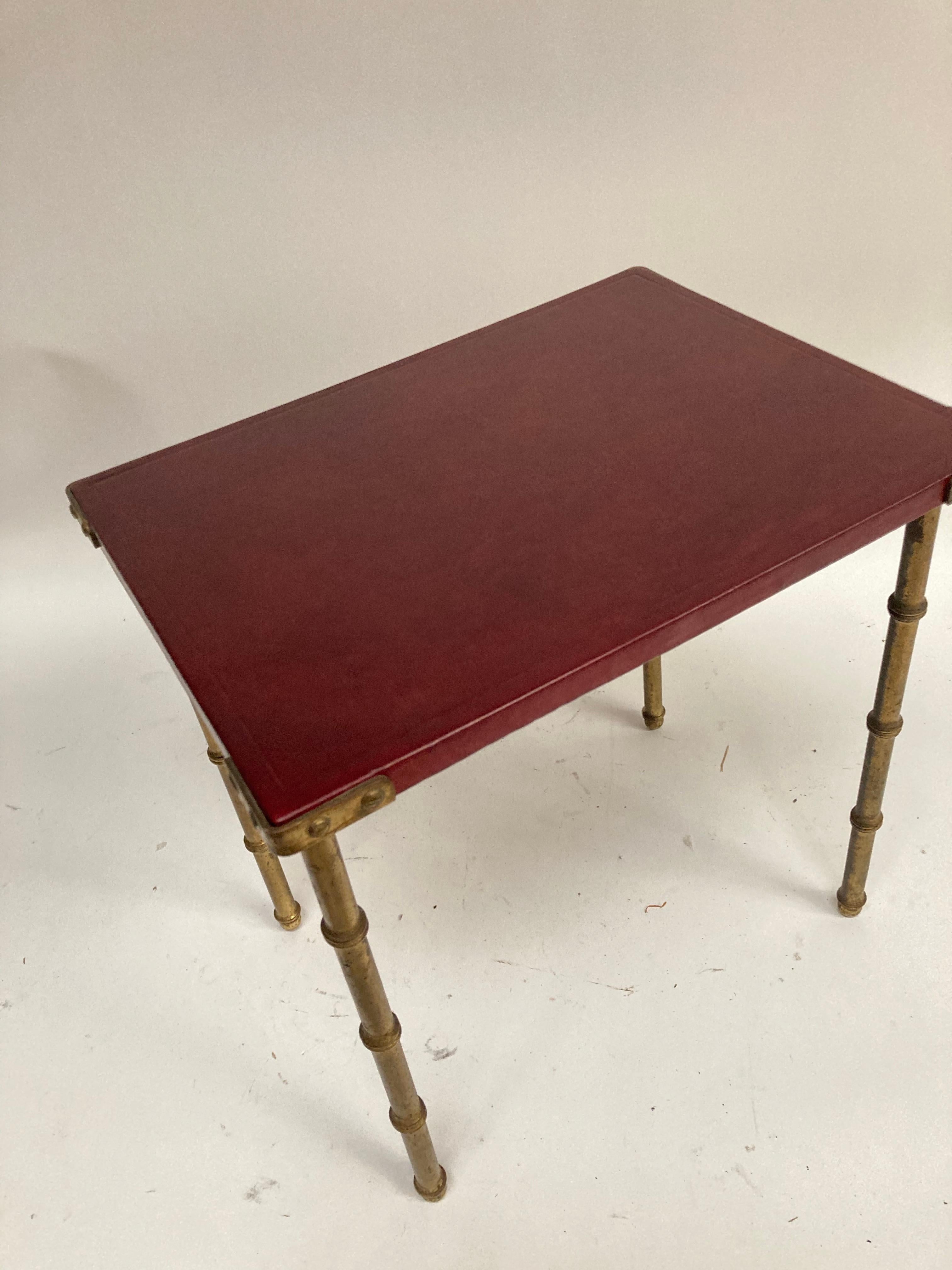 1950's table with burgundy leather top, and brass bambou feet by Jacques Adnet
France.