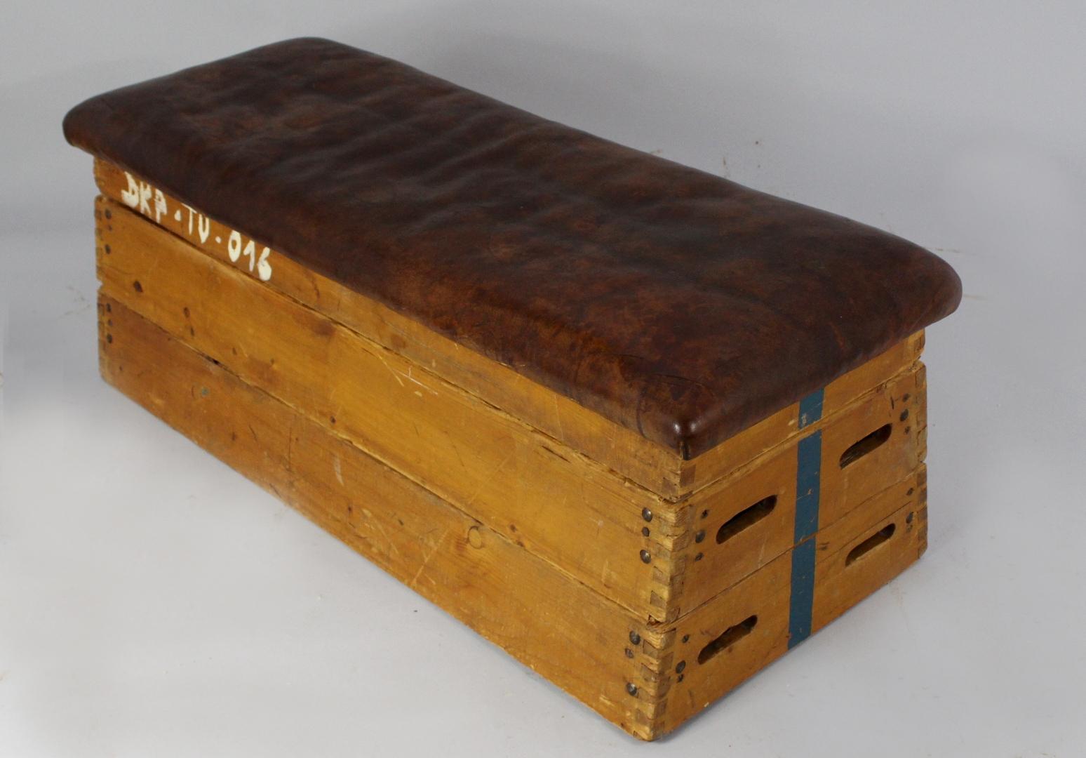 Gymnastic box or bench made in the 1950s. It is made from wood and leather. The box consists of a leather top and five wooden parts. Original condition with great patina.