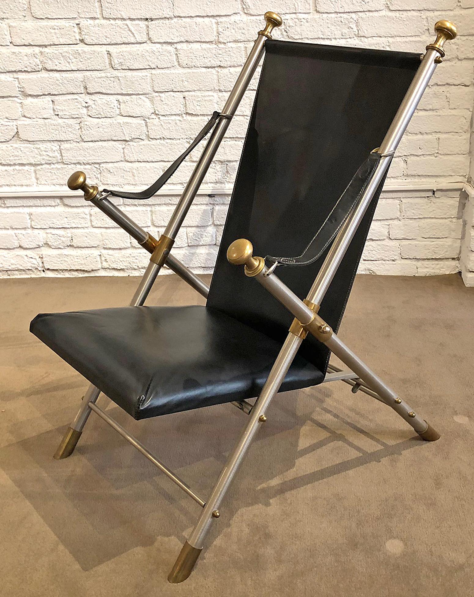 One Campaign chair, featuring saddle leather back and seat along with steel frames and brass details. This is very heavy and is comfortable. Original patina to all metal. The leather has been conditioned. This is ready to use.