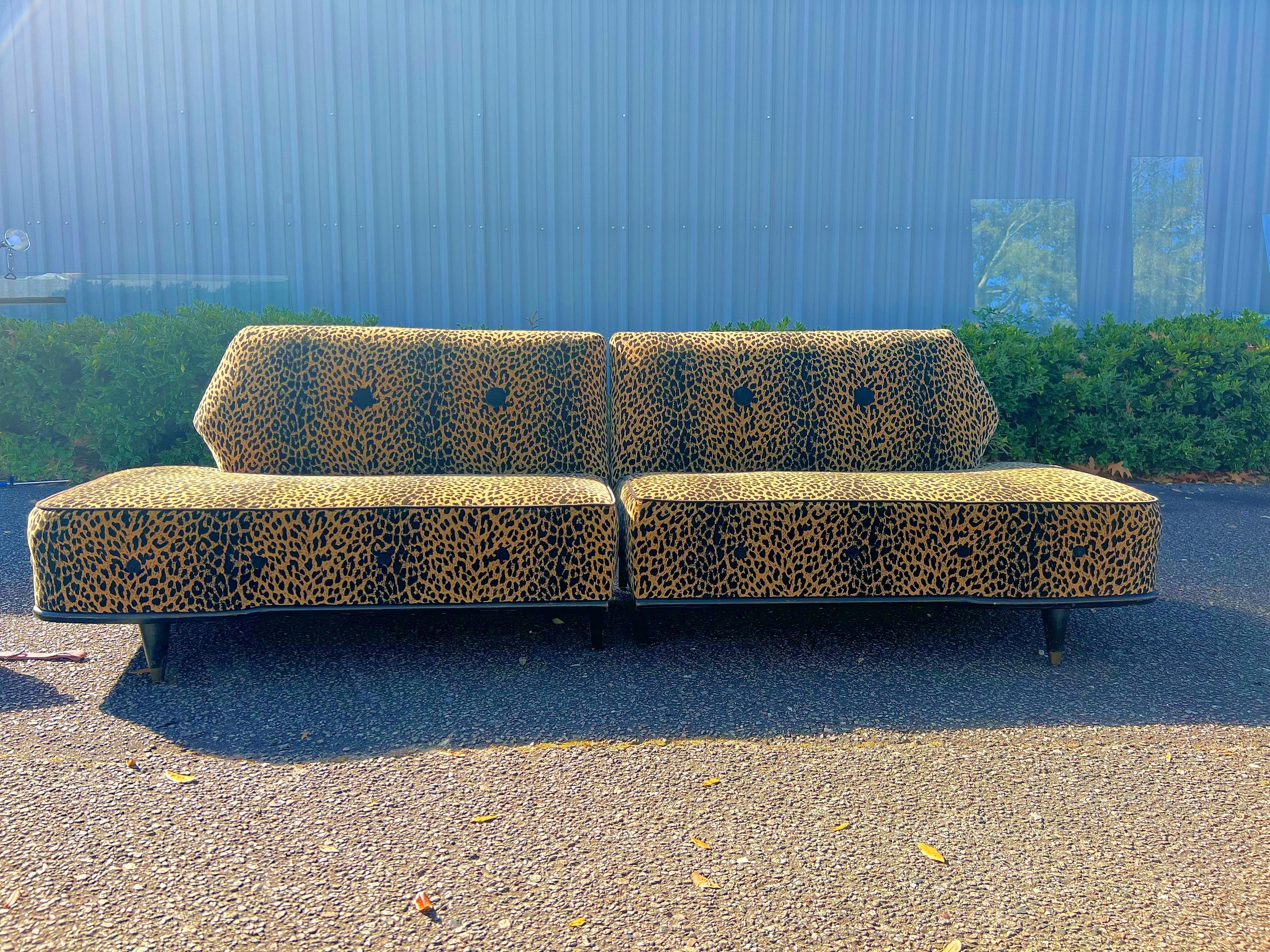 This stunning piece of American Mid-Century Modern early 1950s Biomorphic design for a sofa was re-upholstered in the 1980s and has been lounging in storage ever since. As a result the faux leopard fabric is in excellent condition and the black