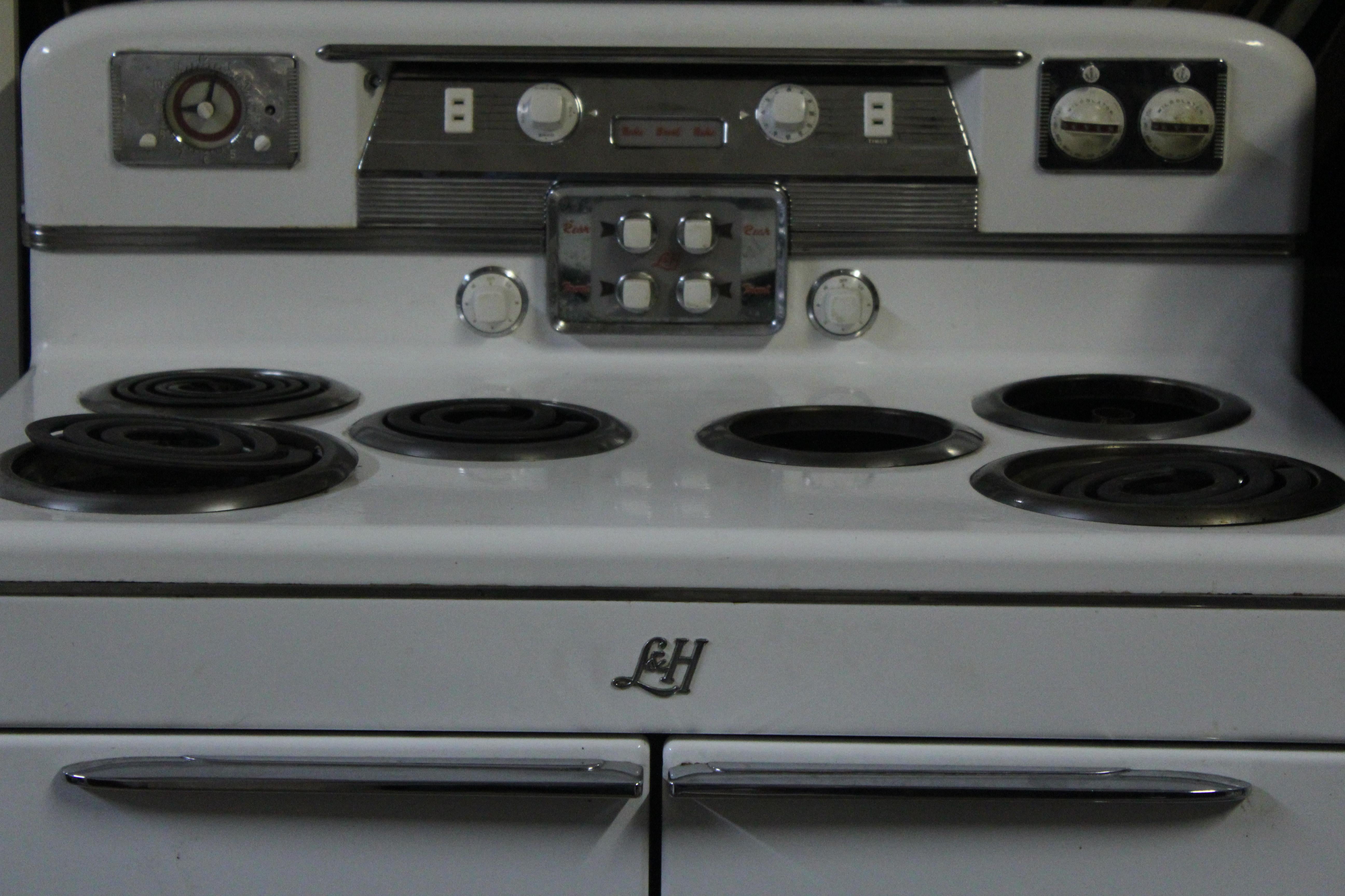 1950s L&H (Lectro-Host) electric 6-burner stove and double oven from A.J. Lindemann & Hoverson Co. (Milwaukee, WI). Includes two broiler drawers, clock/timer and electrical outlet, along with the original manual/recipe booklet.