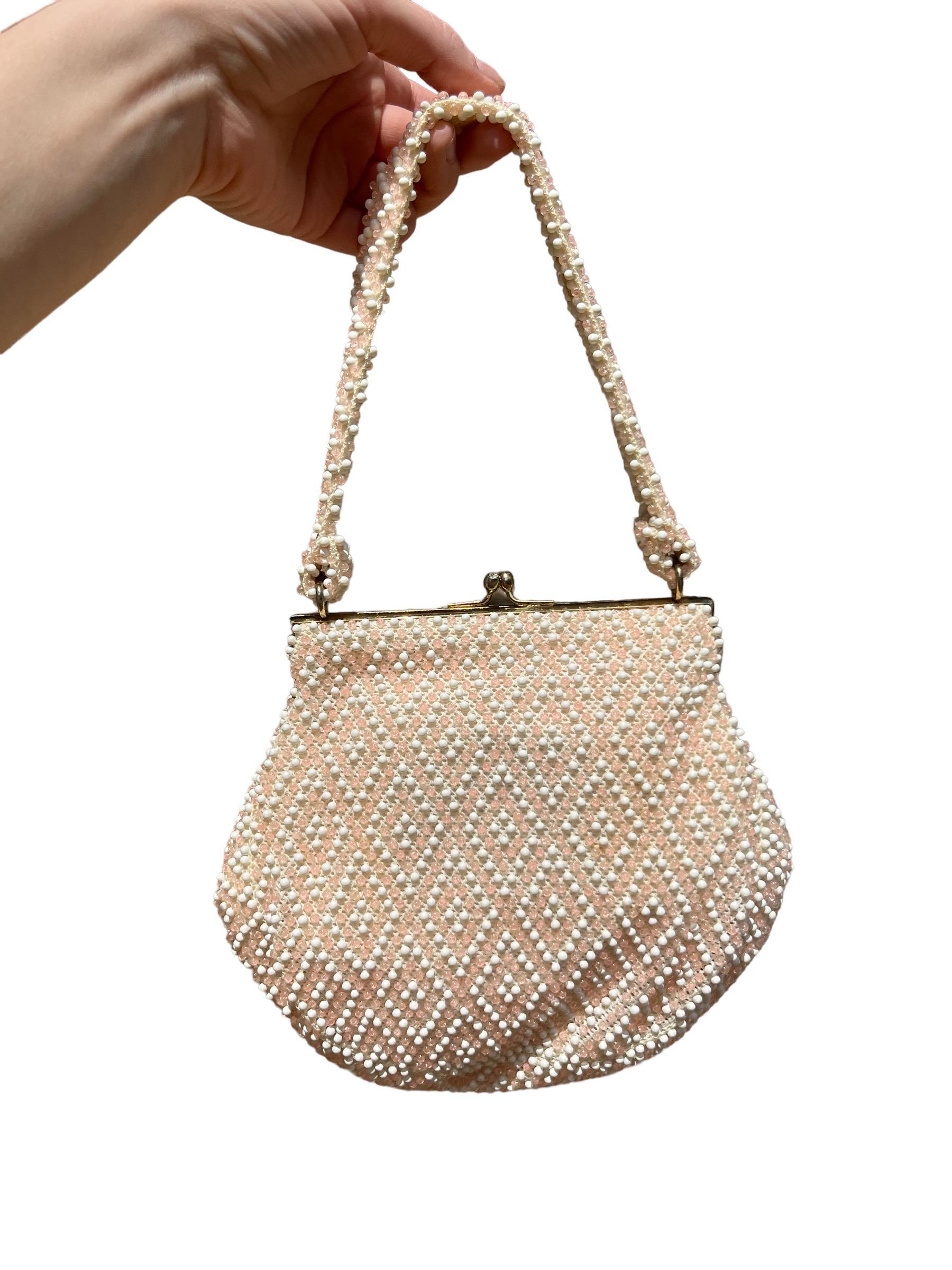 1950’s Light Pink Corde-Bead Bubble Handbag by Lumured

Soft pink purse with white bubble beads in diamond pattern. Sweet rhinestone detail on metal clasp. Comes with original mirror inside pocket! 

Excellent condition!

Measurements:
Width
