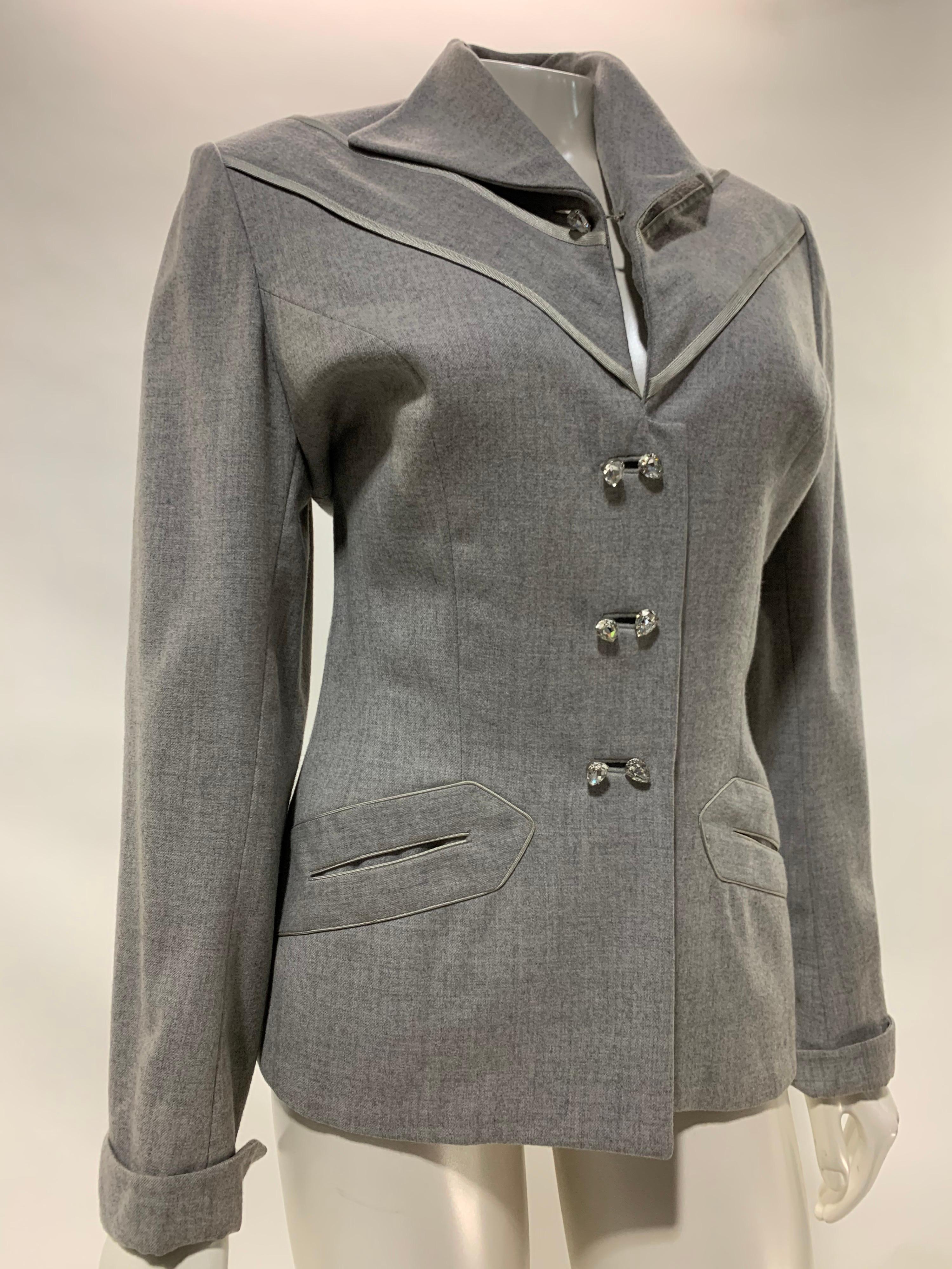 A lovely 1950s Lilli Ann heathered gray wool gabardine jacket with satin angled piping trim in front and doubled teardrop rhinestone buttons (two buttons are used for each button hole.) Front slash pockets, cuffed sleeves. Lined in mauve crepe. Set
