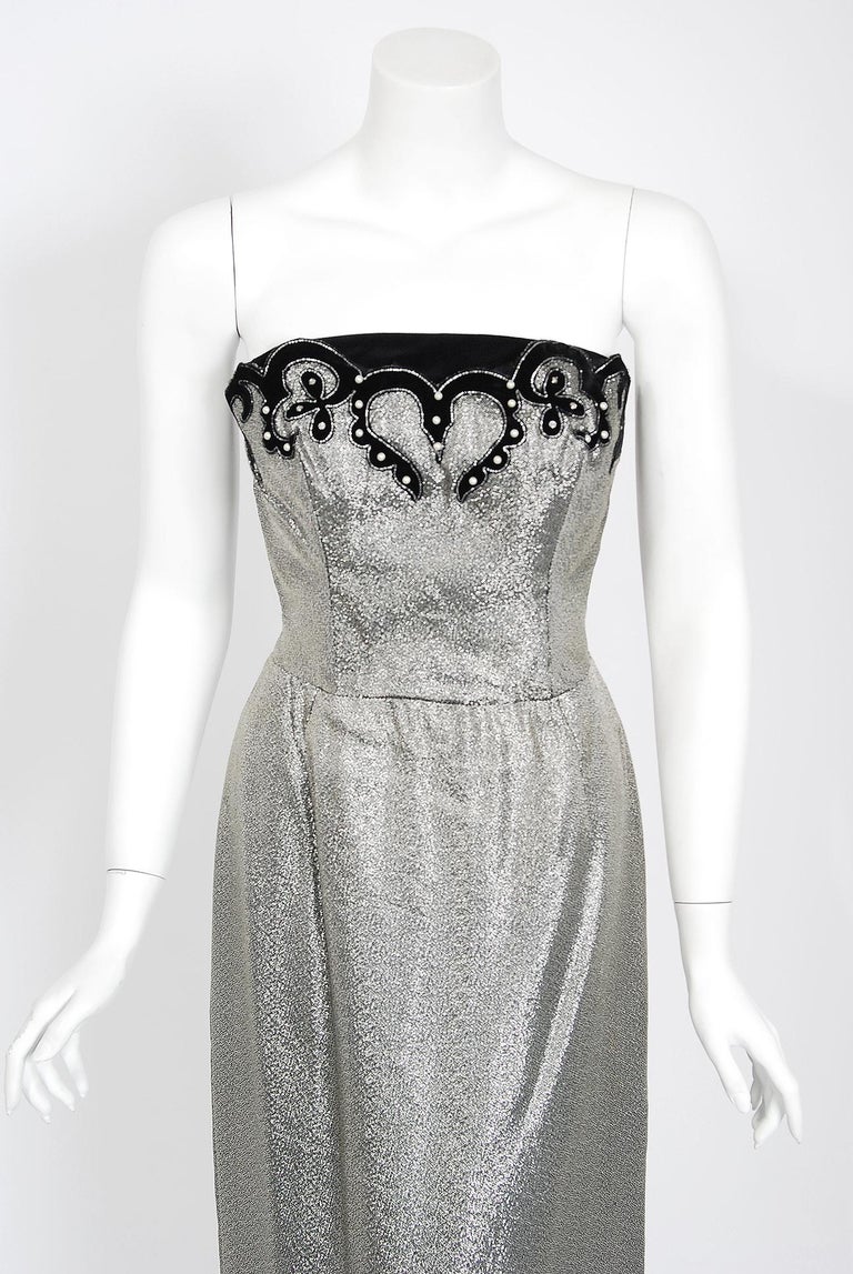 A seductive and highly stylized 1950's sparkling silver lamé dress ensemble by the famous Lilli Diamond label. The silhouette is classic pin-up 