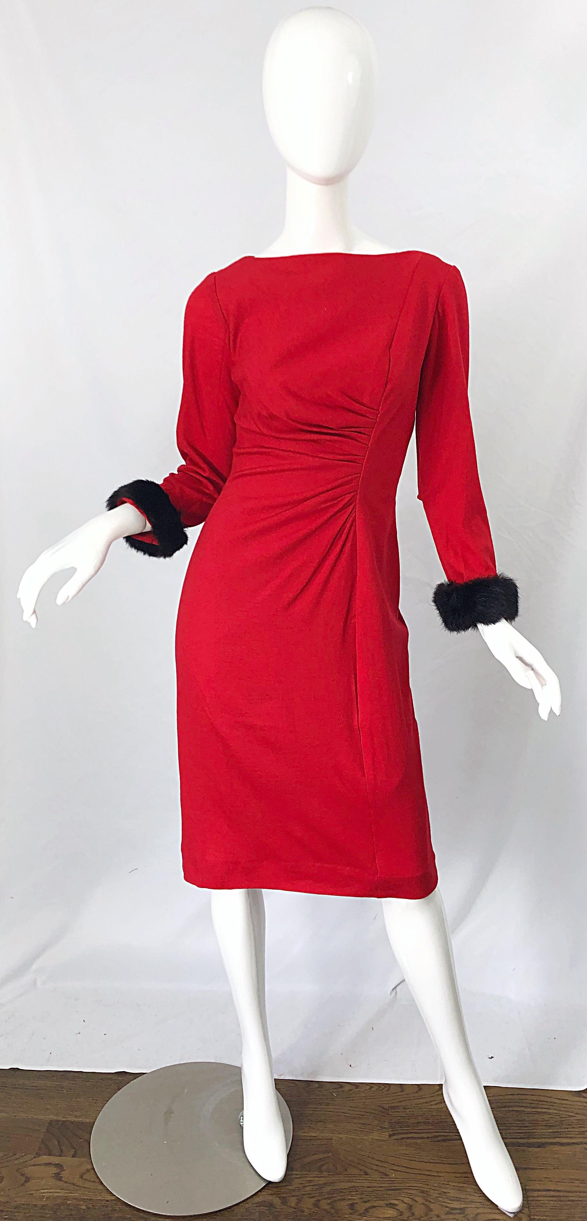 Beautiful 1950s lipstick red wool and mink fur cuffs. Features a soft lightweight wool. Flattering gathers at the waist. Black mink fur at each sleeve cuff. Full metal zipper up the back with hook-and-eye closure. Fully lined. Very well made with