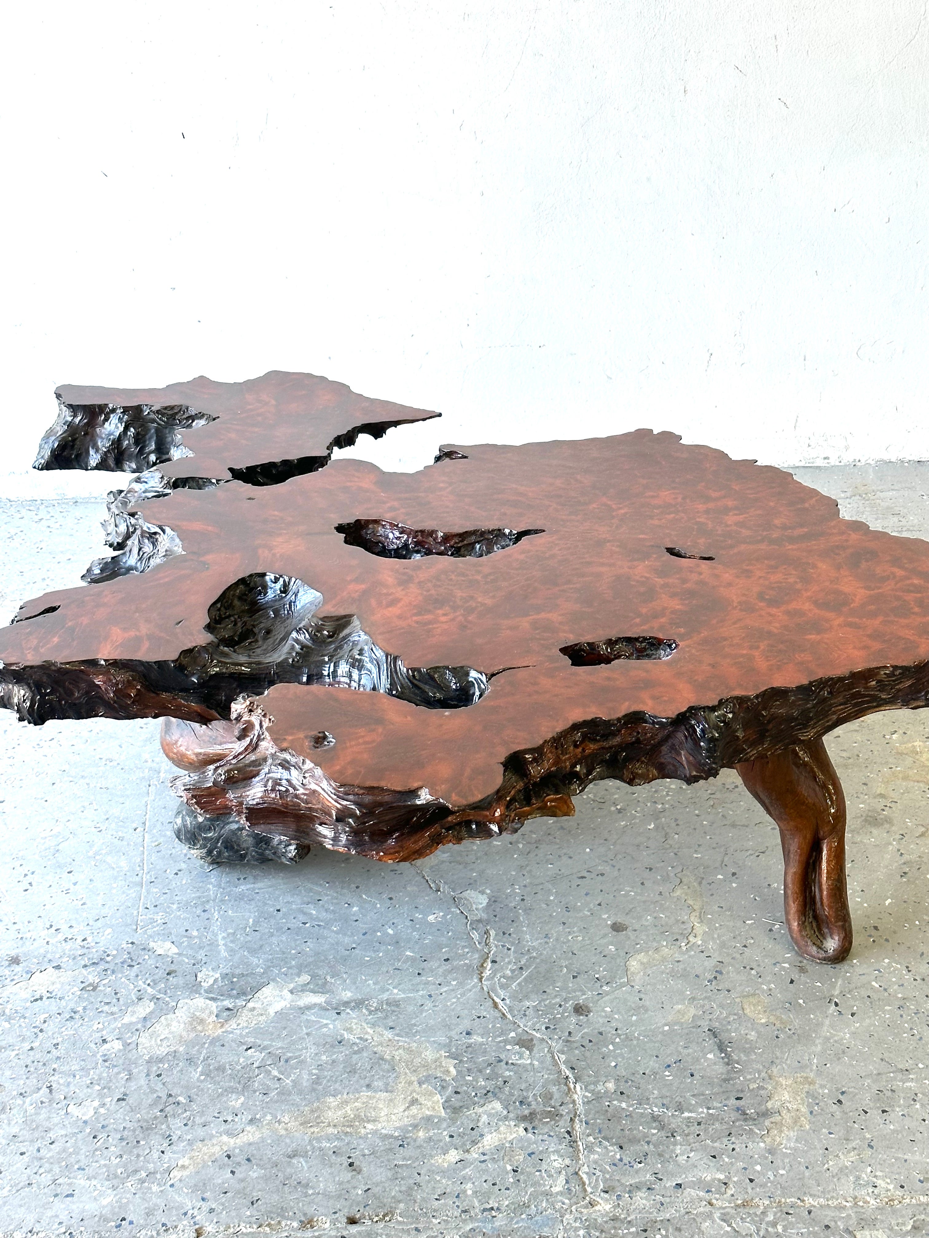 

Live Edge Burl RedWood Wood Coffee Table
This 1960s coffee table has a unique shaped root base and live edge surface. The burl is a natural red wood. The table is finished in a rich deep red stain with a lacquered finish. This coffee table is