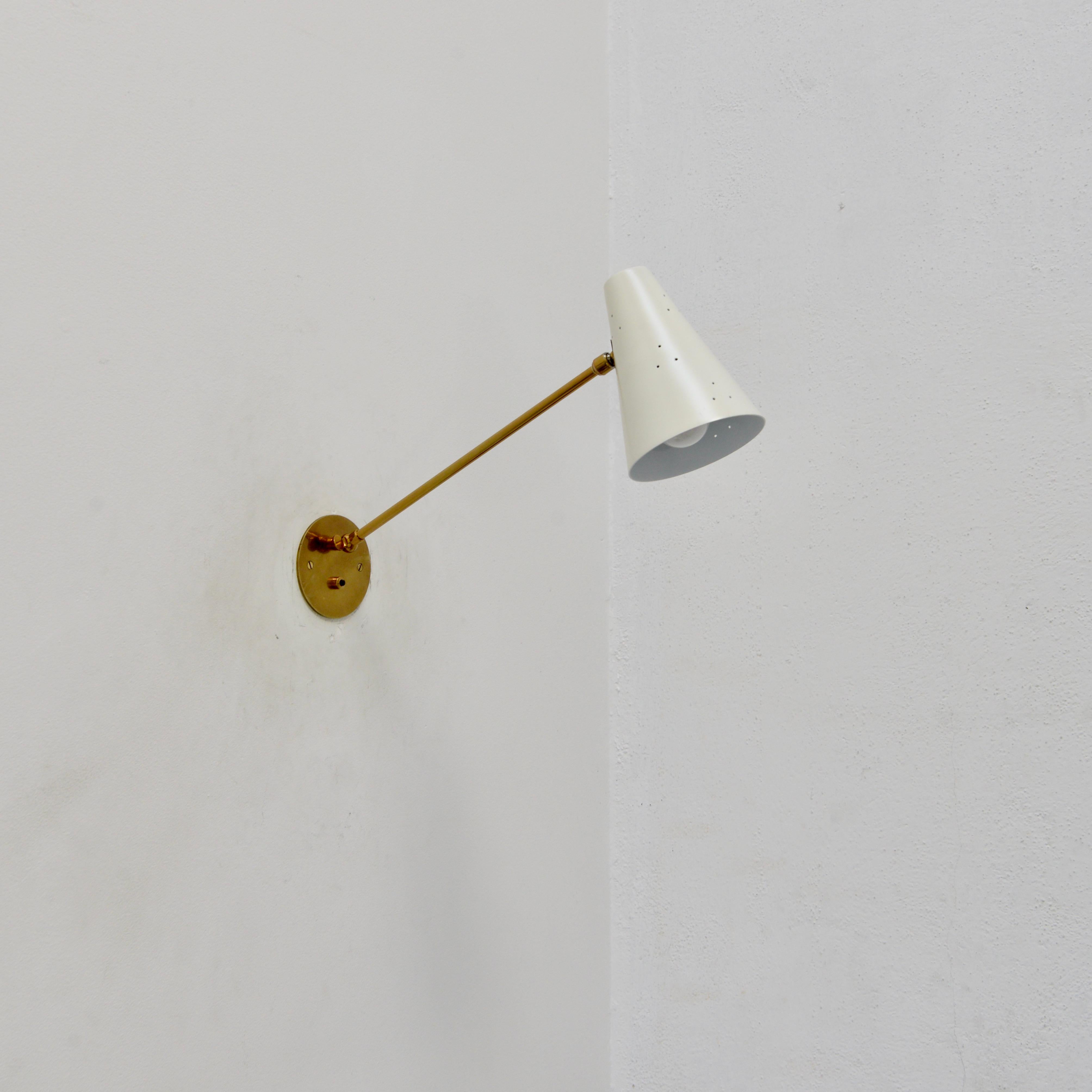 Single fully restored aged brass and painted aluminum long arm Italian Spot Sconce from 1950s Italy. Arm swings and down. Wired with 1 E12 candelabra based socket for use in the USA. Can can also be wired for use anywhere in the world. Lightbulb